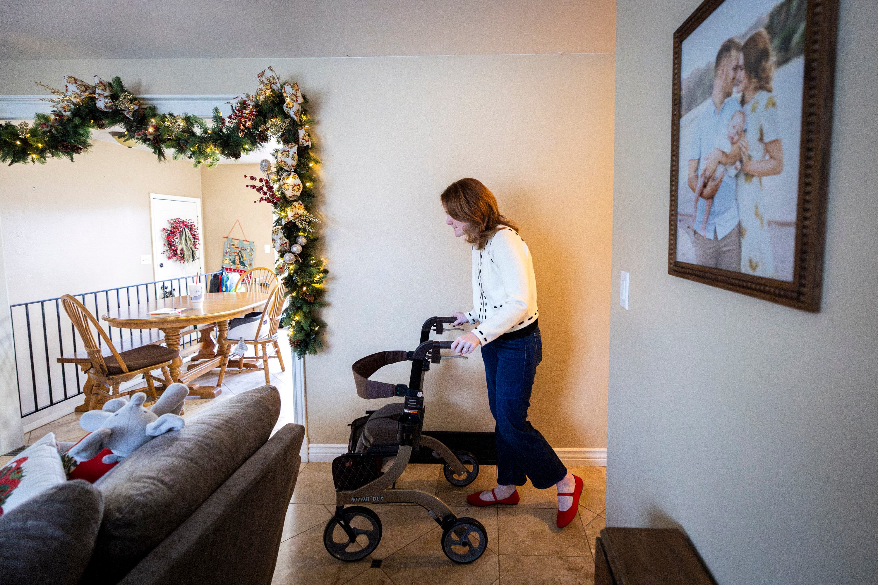 Tiffany Fransen walks toward the kitchen after exiting the office at her family's home in Highland on Dec. 17.