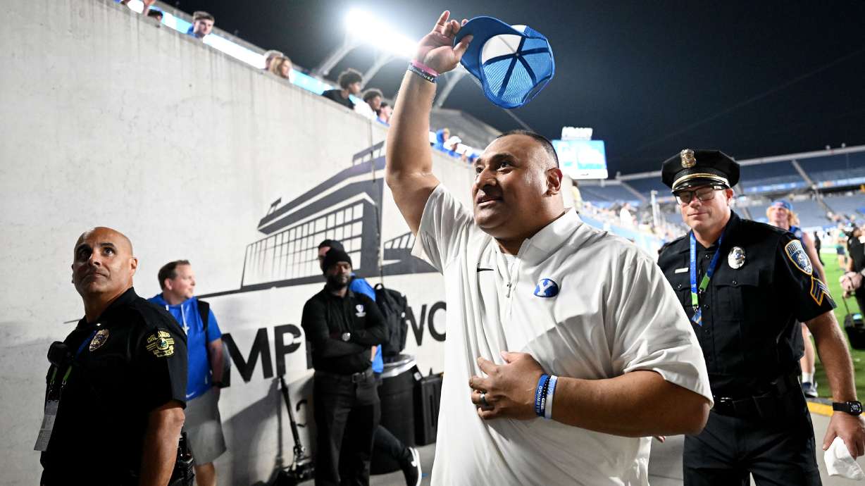 BYU Cougars head coach Kalani Sitake, waves his hat toward fans as he leaves the field after the Cougars 25-21 win over the Georgia Tech Yellow Jackets in the Pop Tarts Bowl in Orlando on Saturday, Dec. 27, 2025.