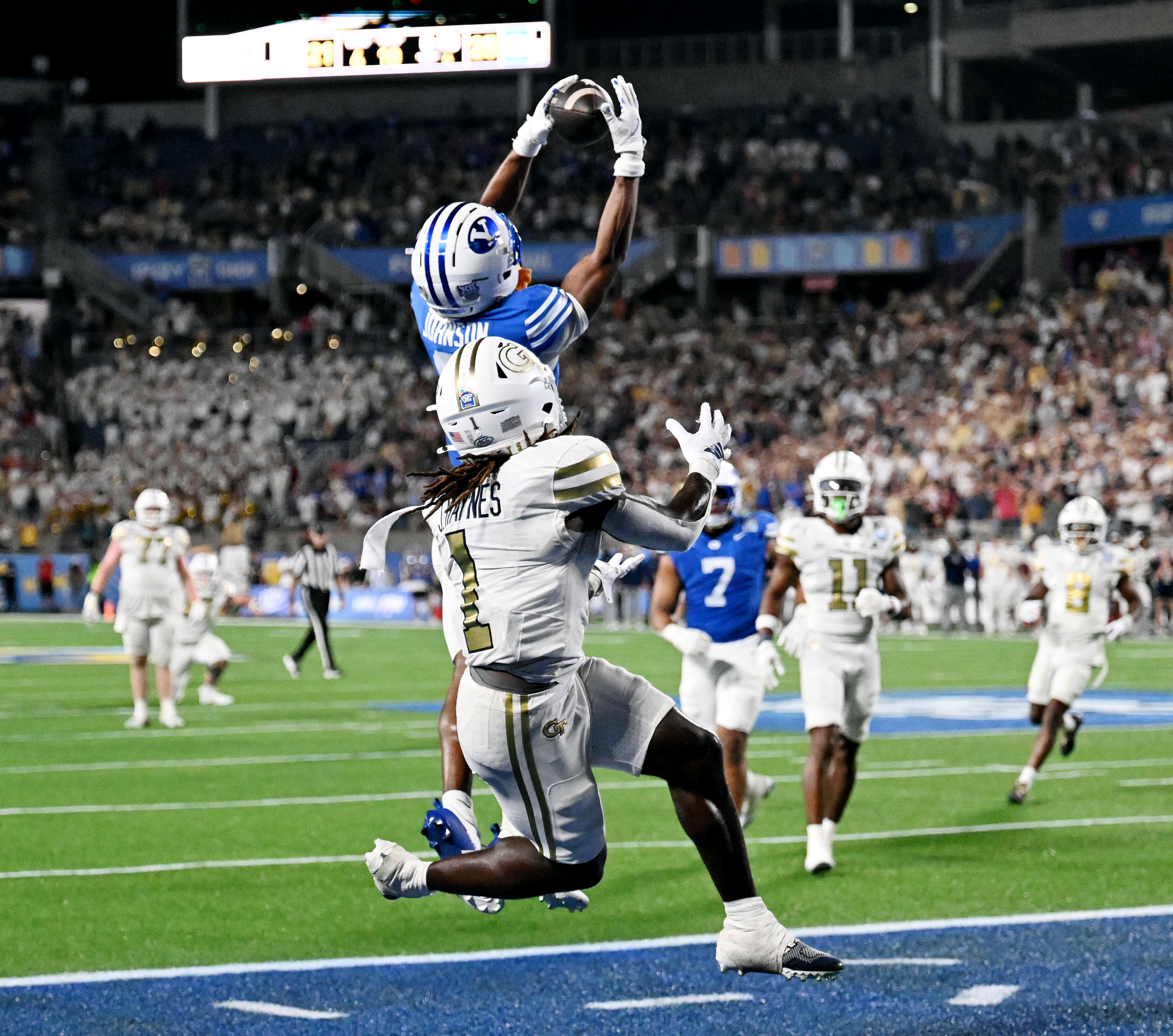 BYU Cougars defensive back Evan Johnson (0) intercepts a pass to Georgia Tech Yellow Jackets running back Jamal Haynes (1) in the endzone sealing the 25-21 win for the Cougars in the Pop-Tarts Bowl in Orlando on Saturday, Dec. 27, 2025.