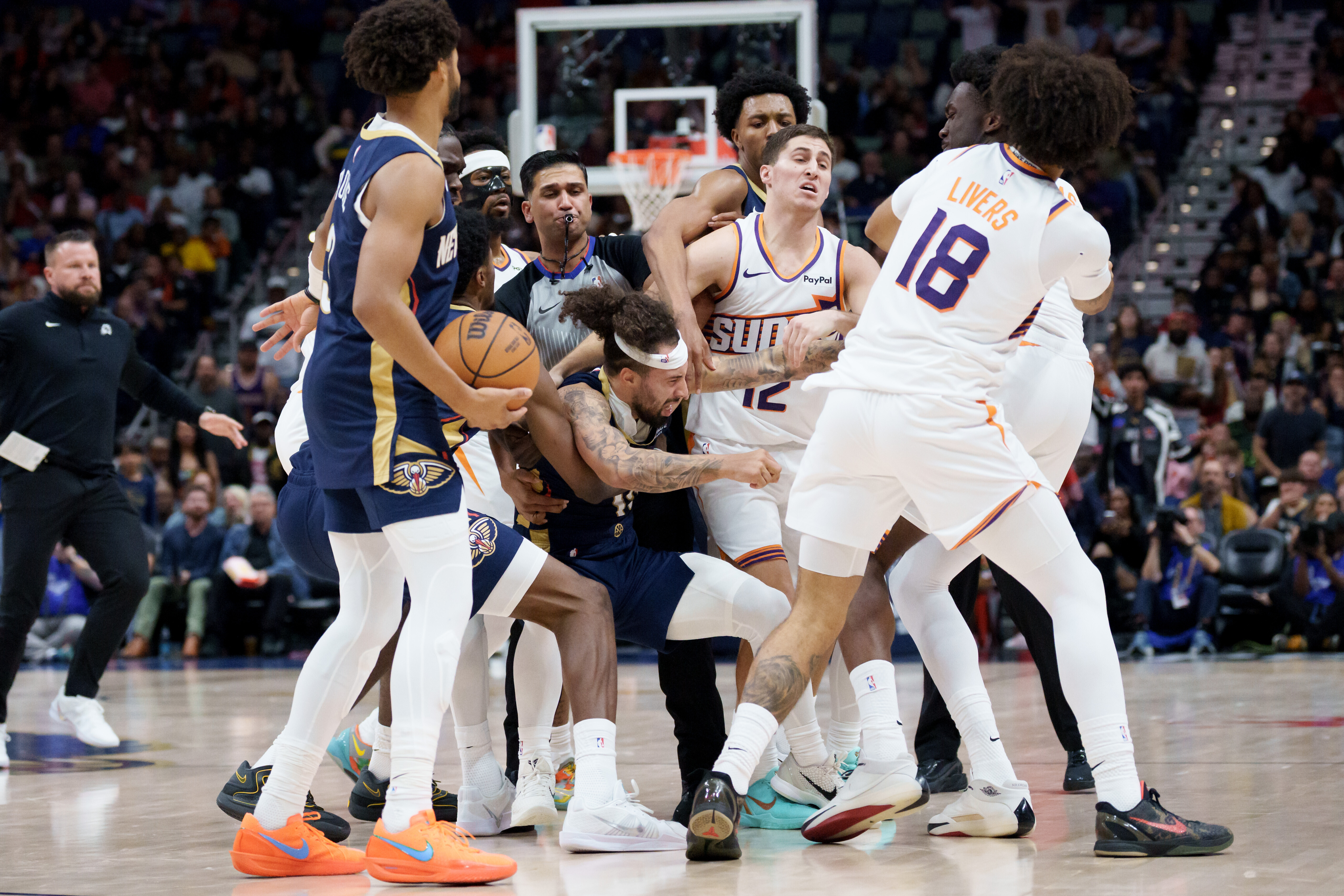 New Orleans Pelicans guard Jose Alvarado (15) and Phoenix Suns center Mark Williams get into a scrum during the third quarter before both were ejected during an NBA basketball game in New Orleans, Saturday, Dec. 27, 2025.