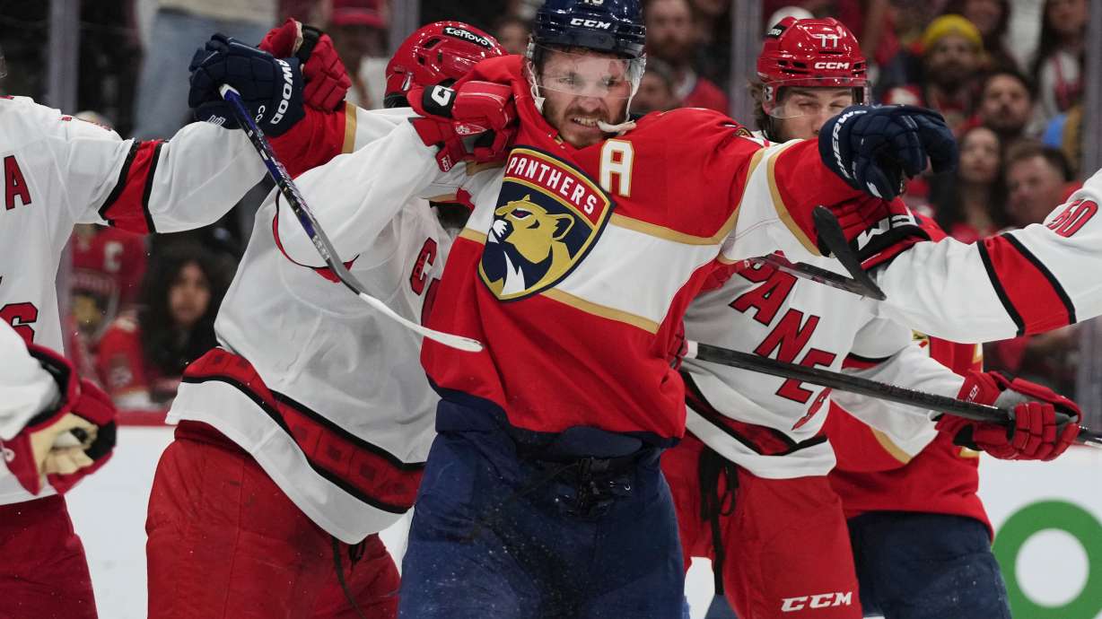 FILE - Florida Panthers left wing Matthew Tkachuk (19) scuffles with Carolina Hurricanes players during the second period in Game 3 of the NHL hockey Stanley Cup Eastern Conference finals Saturday, May 24, 2025, in Sunrise, Fla.