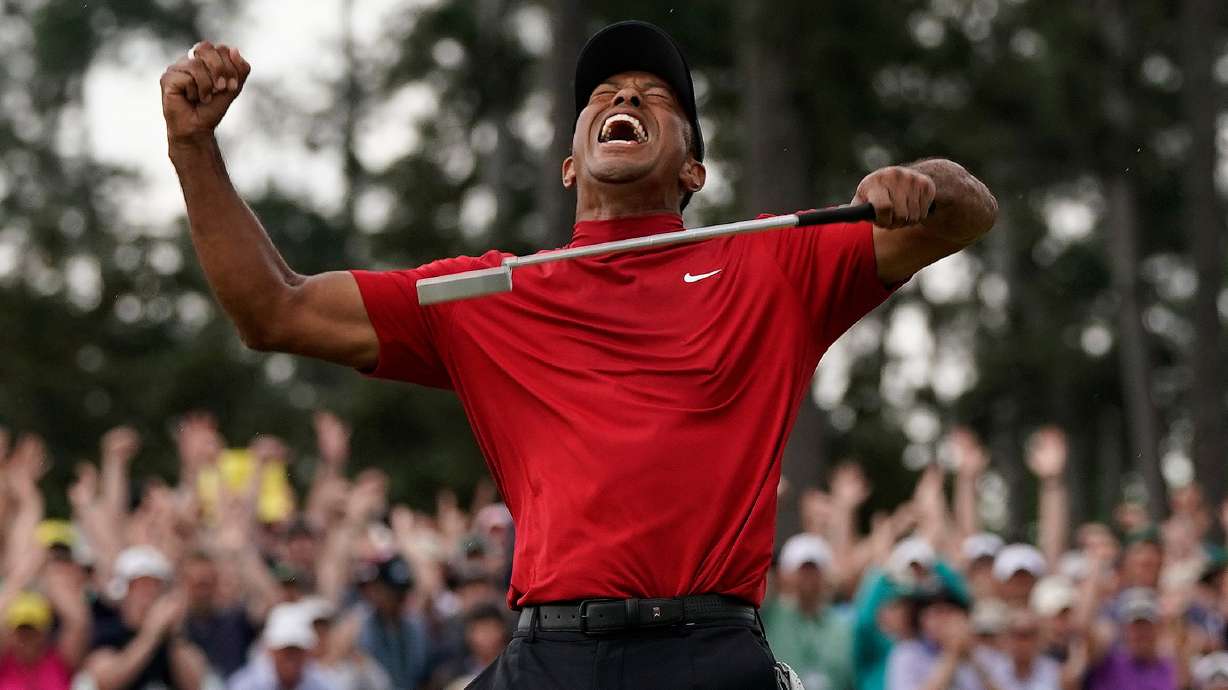 FILE - Tiger Woods reacts as he wins the Masters golf tournament, Sunday, April 14, 2019, in Augusta, Ga.