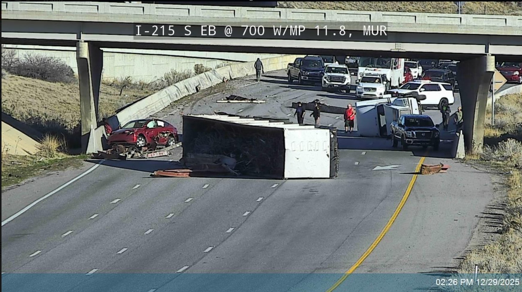 A rollover crash involving a semitruck forced closures of freeway lanes near the I-15 and I-215 interchange in Murray, Monday.
