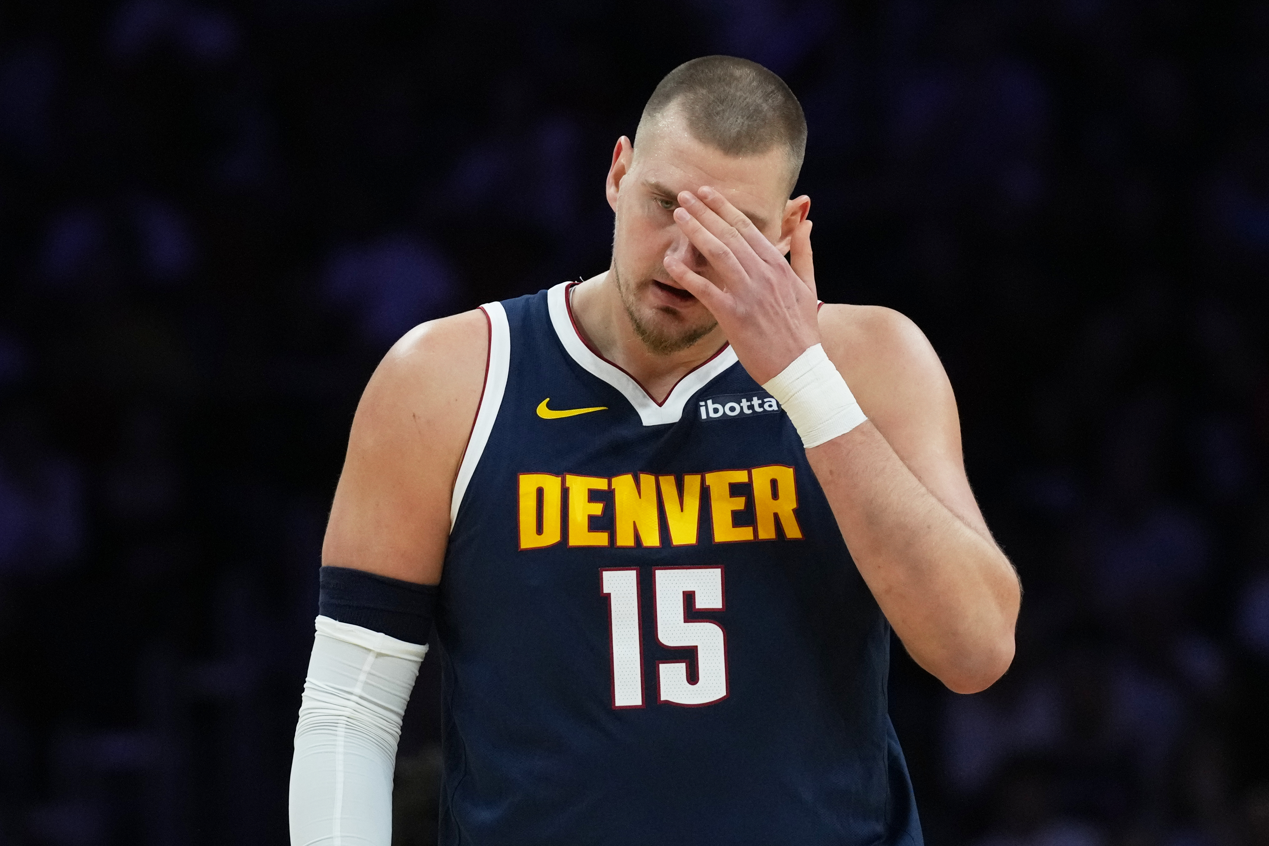 Denver Nuggets center Nikola Jokic (15) walks on the court during the first half of an NBA basketball game against the Miami Heat, Monday, Dec. 29, 2025, in Miami.