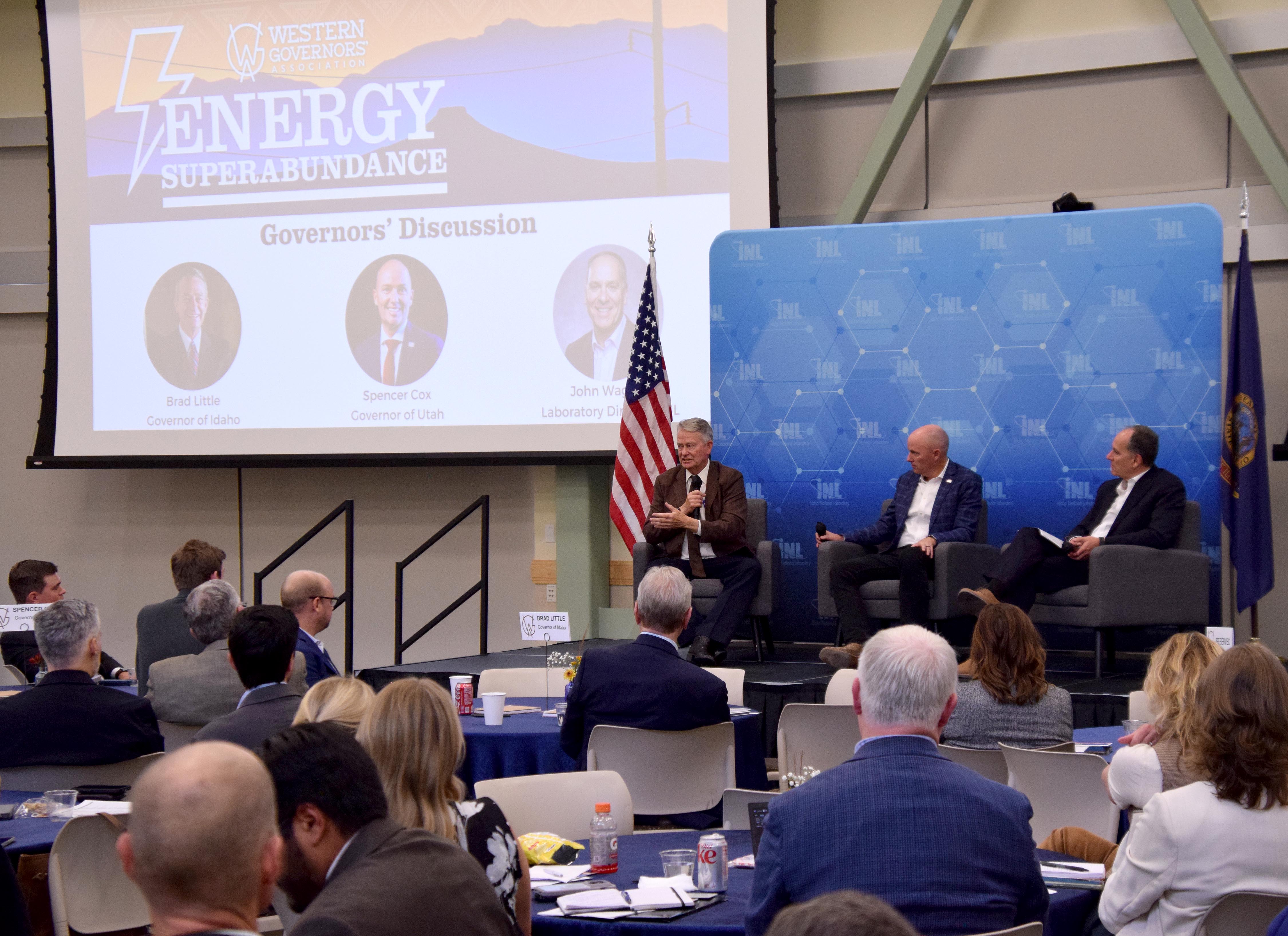 Idaho Gov. Brad Little, left, speaks while Gov. Spencer Cox and Idaho National Laboratory director John Wagner both listen during a panel discussion at the Energy Superabundance conference hosted by the Western Governors’ Association at Idaho National Laboratory in Idaho Falls, Sept. 22, 2025.