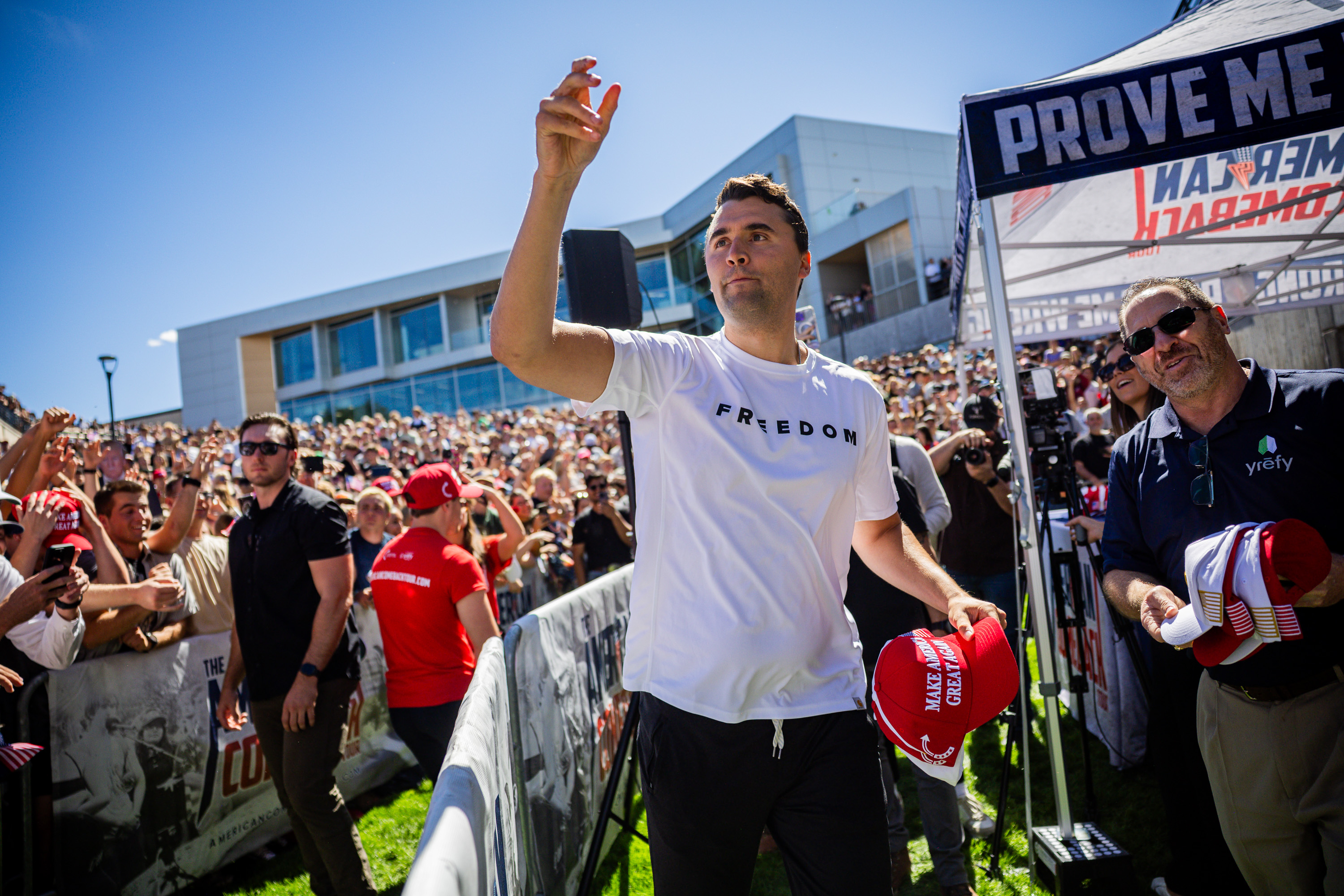 Charlie Kirk hands out hats before he is fatally shot during Turning Point USA’s visit to Utah Valley University in Orem on Sept. 10.
