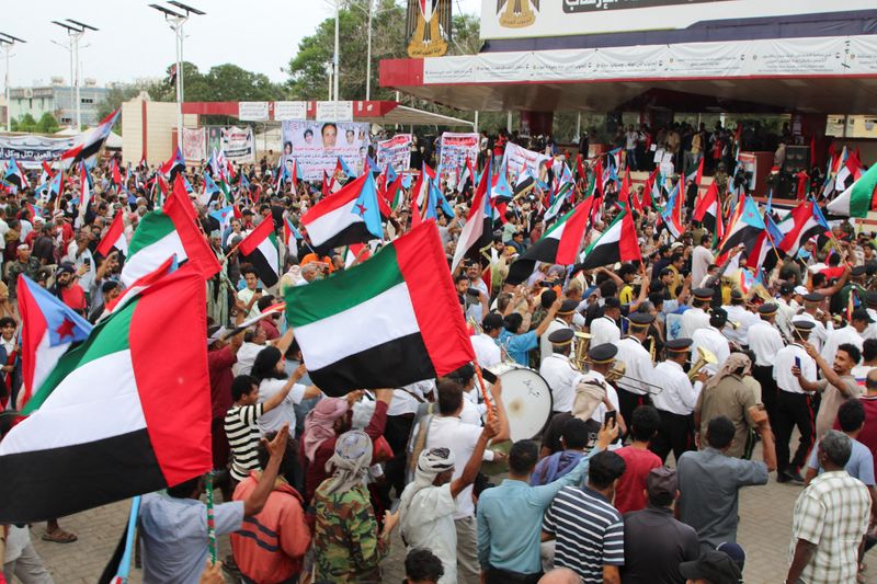 Supporters of the UAE-backed separatist Southern Transitional Council wave flags of the United Arab Emirates and of the STC, during a rally in Aden, Yemen, Tuesday. The UAE has been accused of fueling strife in Yemen following an airstrike.
