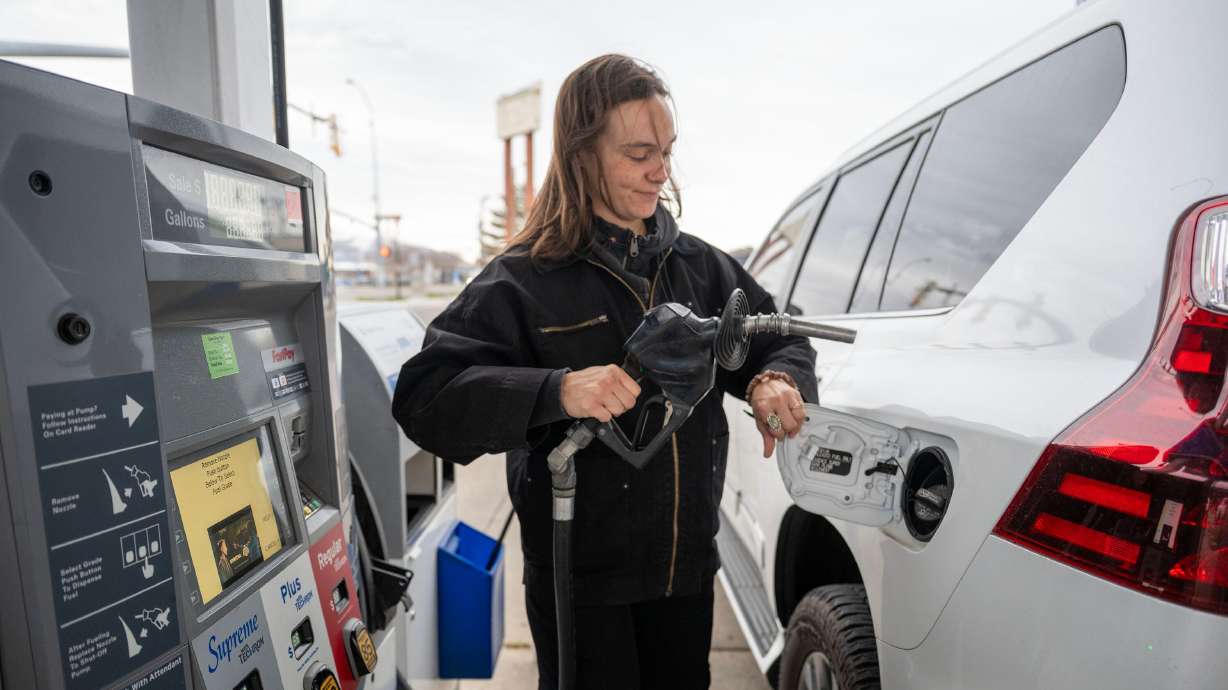 Megan Ali holds the gas nozzle before filling her car at a station on State Street in Salt Lake City on Dec. 19. Utah, according to the State Tax Commission, recorded its highest rate of state gas taxes at 38.5 cents per gallon in 2025.