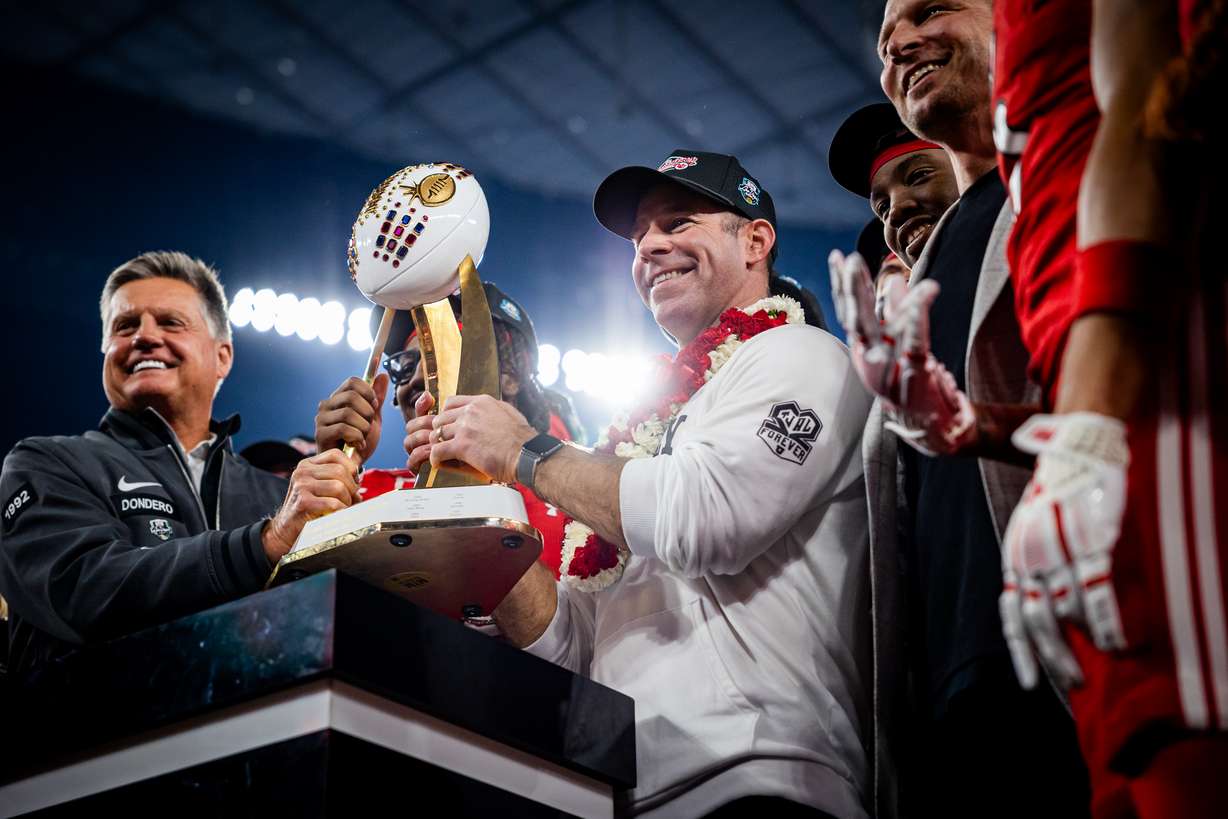 Utah Utes head coach Morgan Scalley holds the trophy given to the Utah Utes for winning the Las Vegas Bowl against the Nebraska Cornhuskers at Allegiant Stadium in Las Vegas on Wednesday, Dec. 31, 2025.