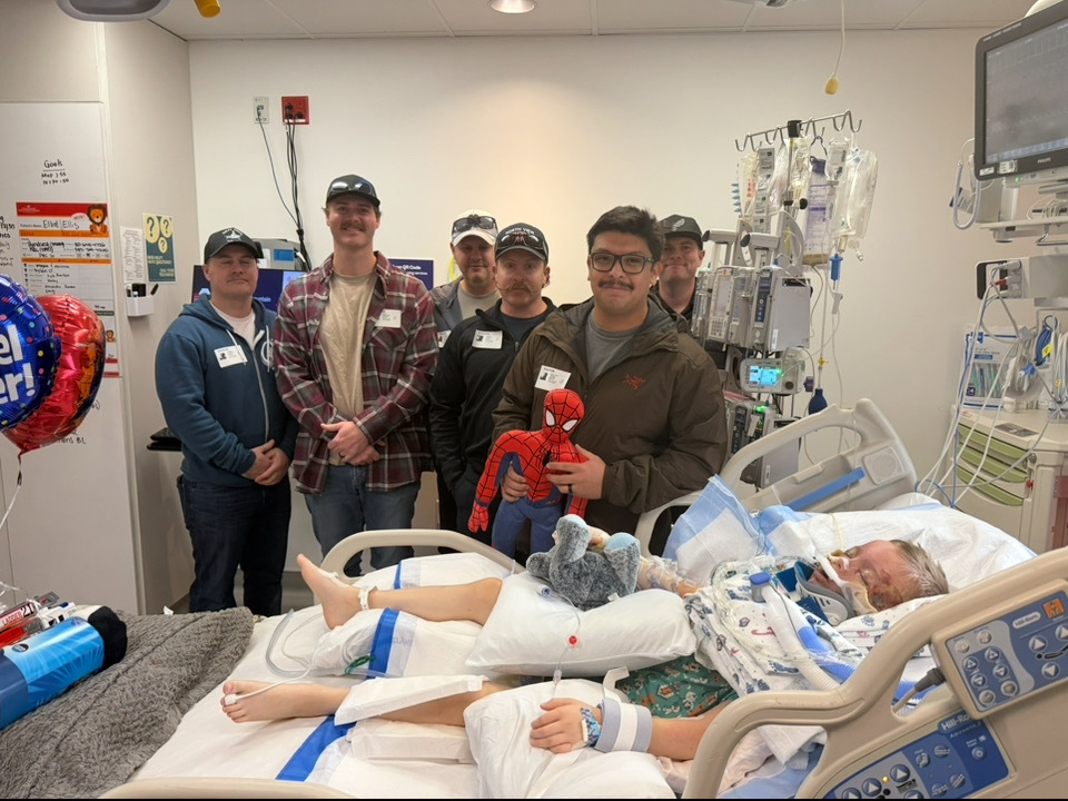 First responders visit  Elliott Ellis (bottom right) on Tuesday. The boy was critically injured after being hit by a car in Pleasant View last Friday.