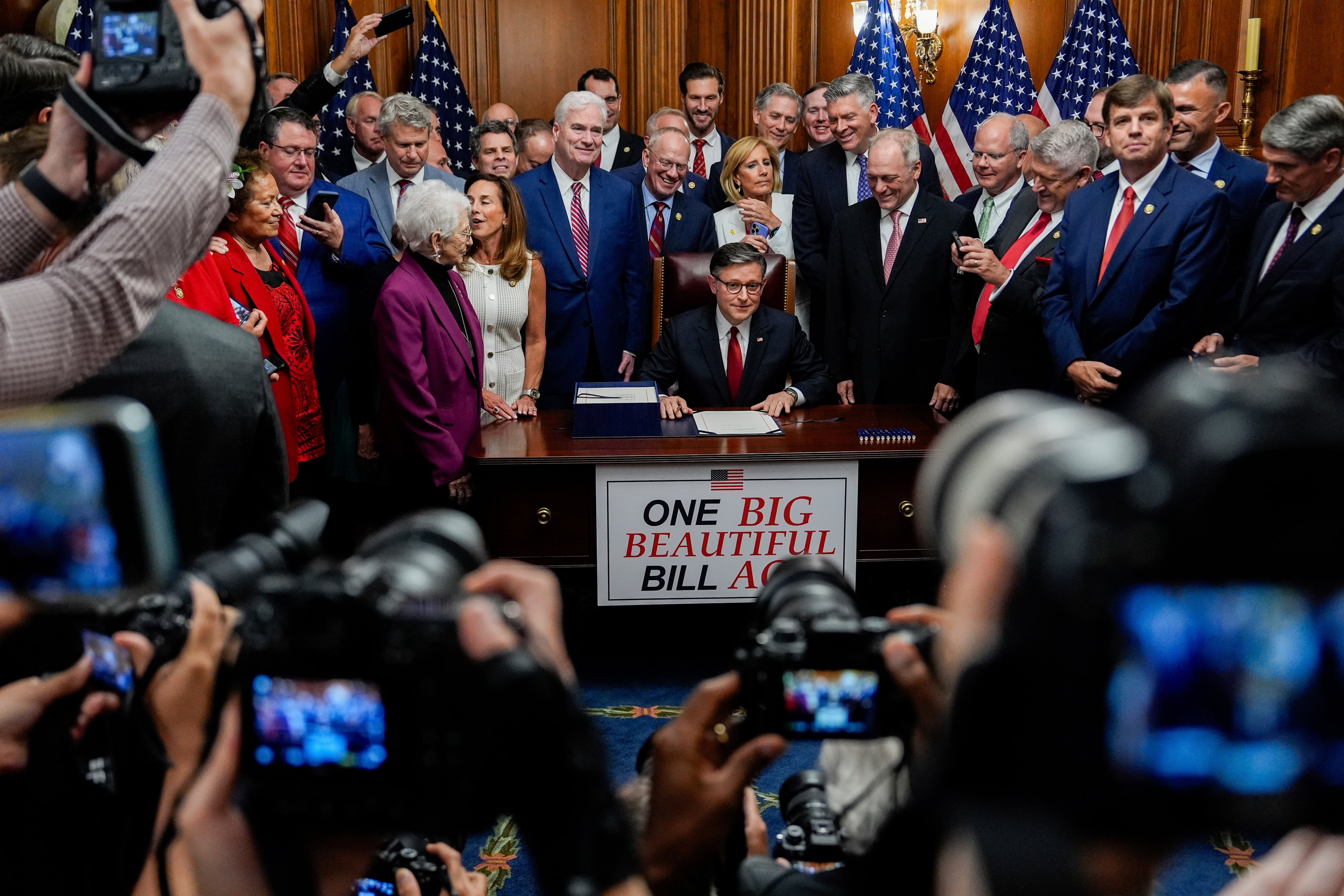 Speaker of the House Mike Johnson, R-La., surrounded by Republican members of Congress, signs President Donald Trump's signature bill of tax breaks and spending cuts, July 3, 2025, at the Capitol in Washington. Utah Sen. Mike Lee's public lands proposals were pulled from the bill before it was passed.