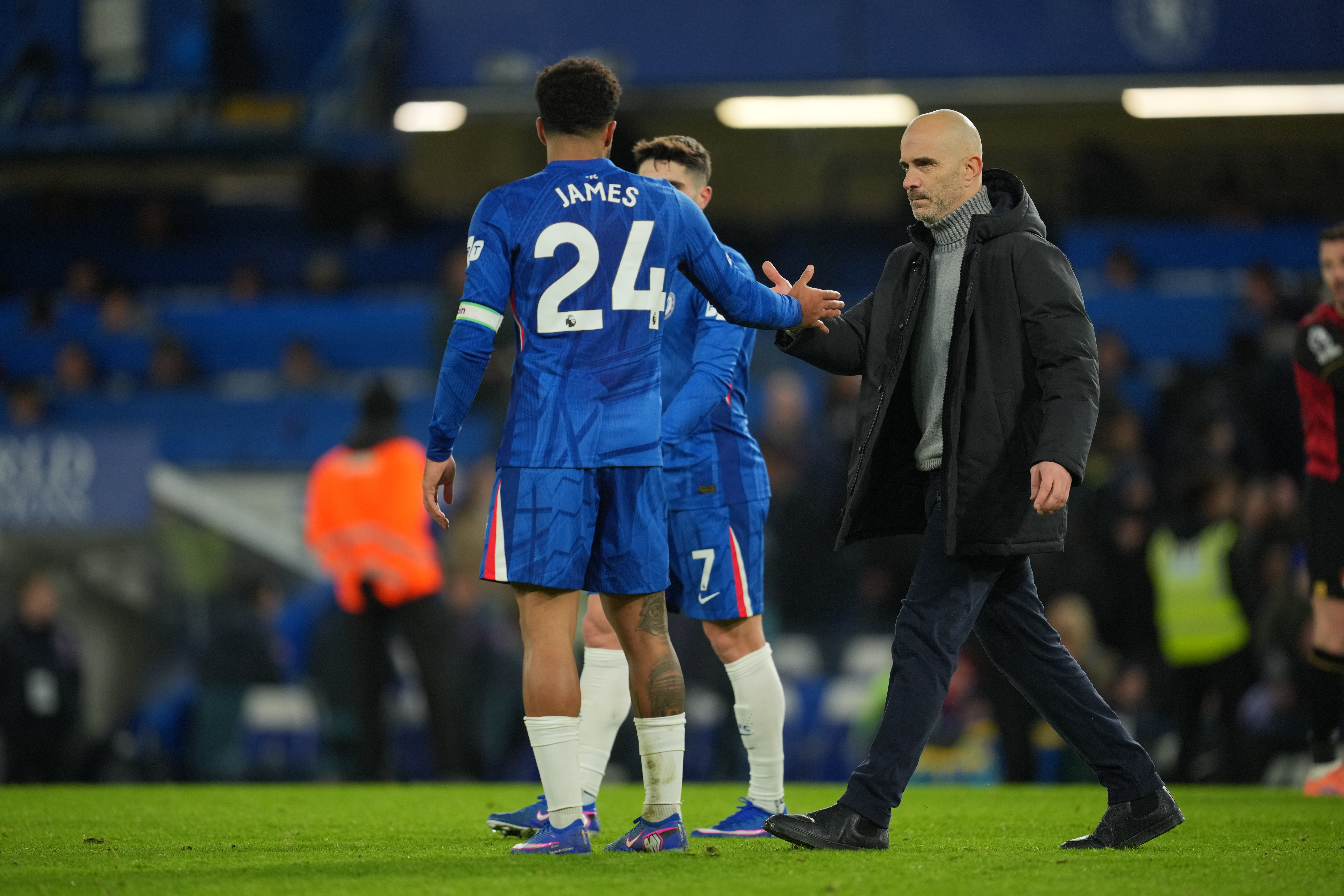 Chelsea's head coach Enzo Maresca, right, shakes hands with Reece James after the English Premier League soccer match between Chelsea and Bournemouth in London, England, Tuesday, Dec. 30, 2025.