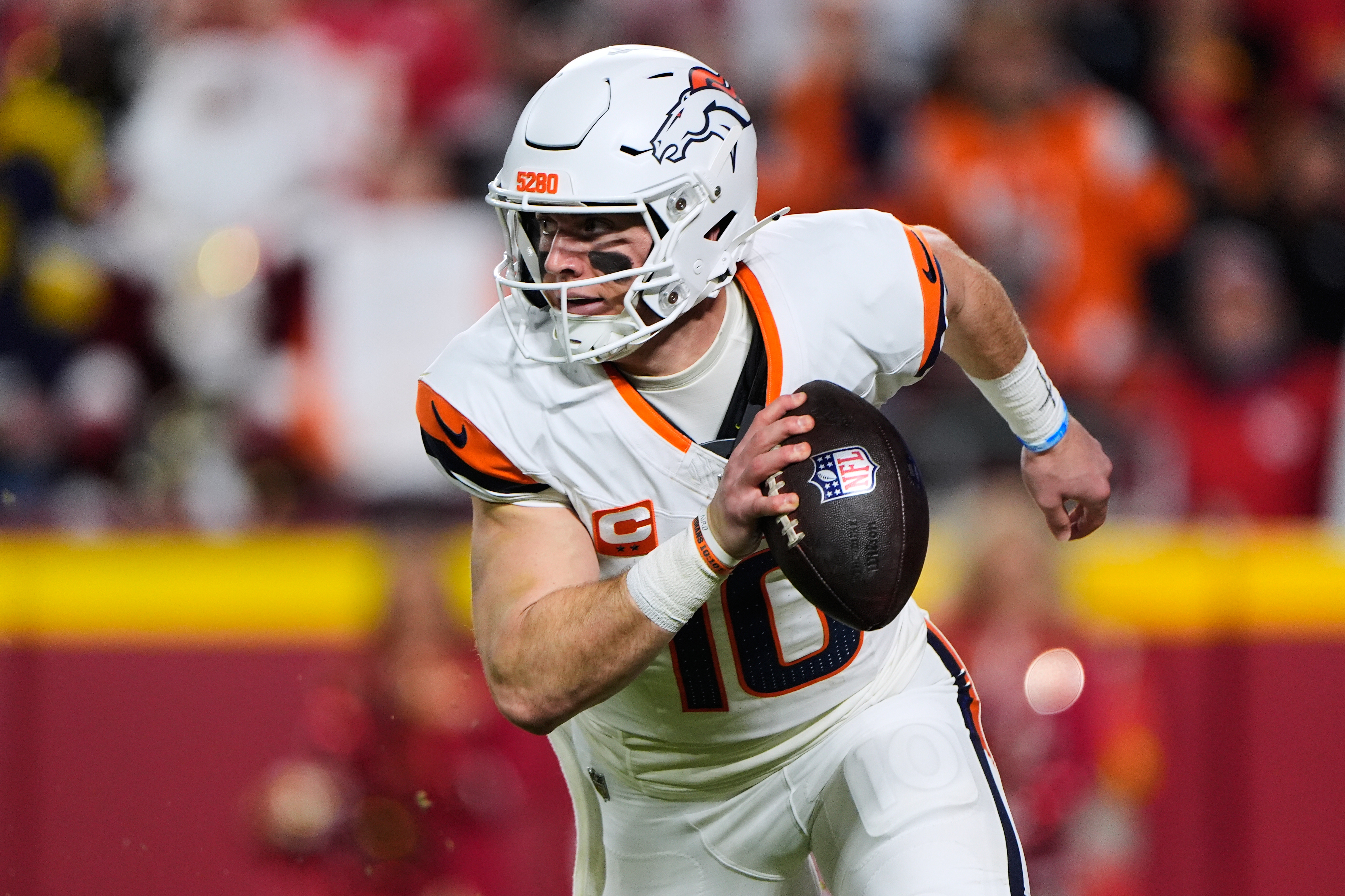 Denver Broncos quarterback Bo Nix runs the ball during the first half of an NFL football game against the Kansas City Chiefs, Thursday, Dec. 25, 2025, in Kansas City, Mo.
