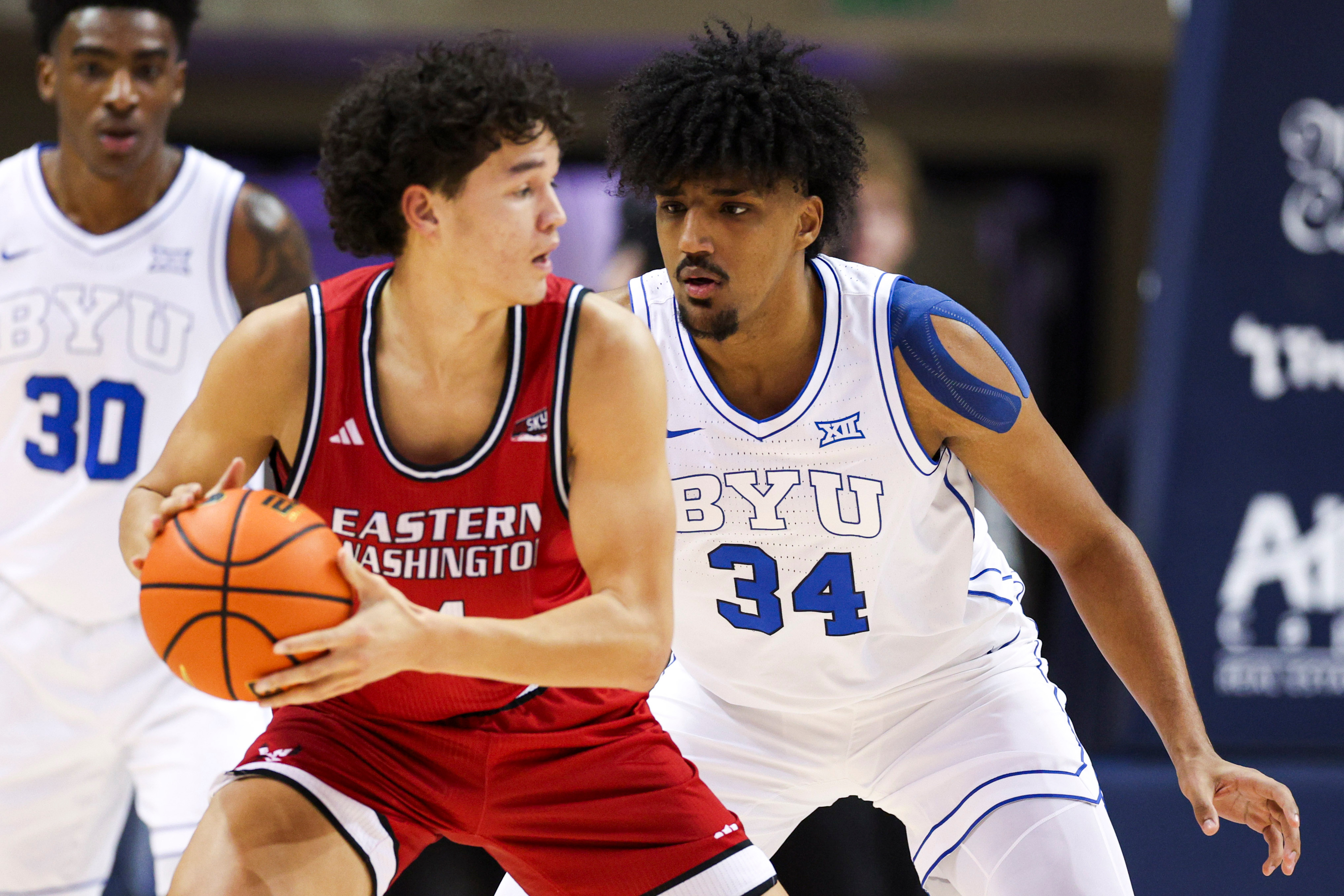 BYU center Abdullah Ahmed (34) defends Eastern Washington Eagles forward Alton Hamilton IV (4) during the first half of a basketball game at the Marriott Center in Provo on Monday, Dec. 22, 2025.