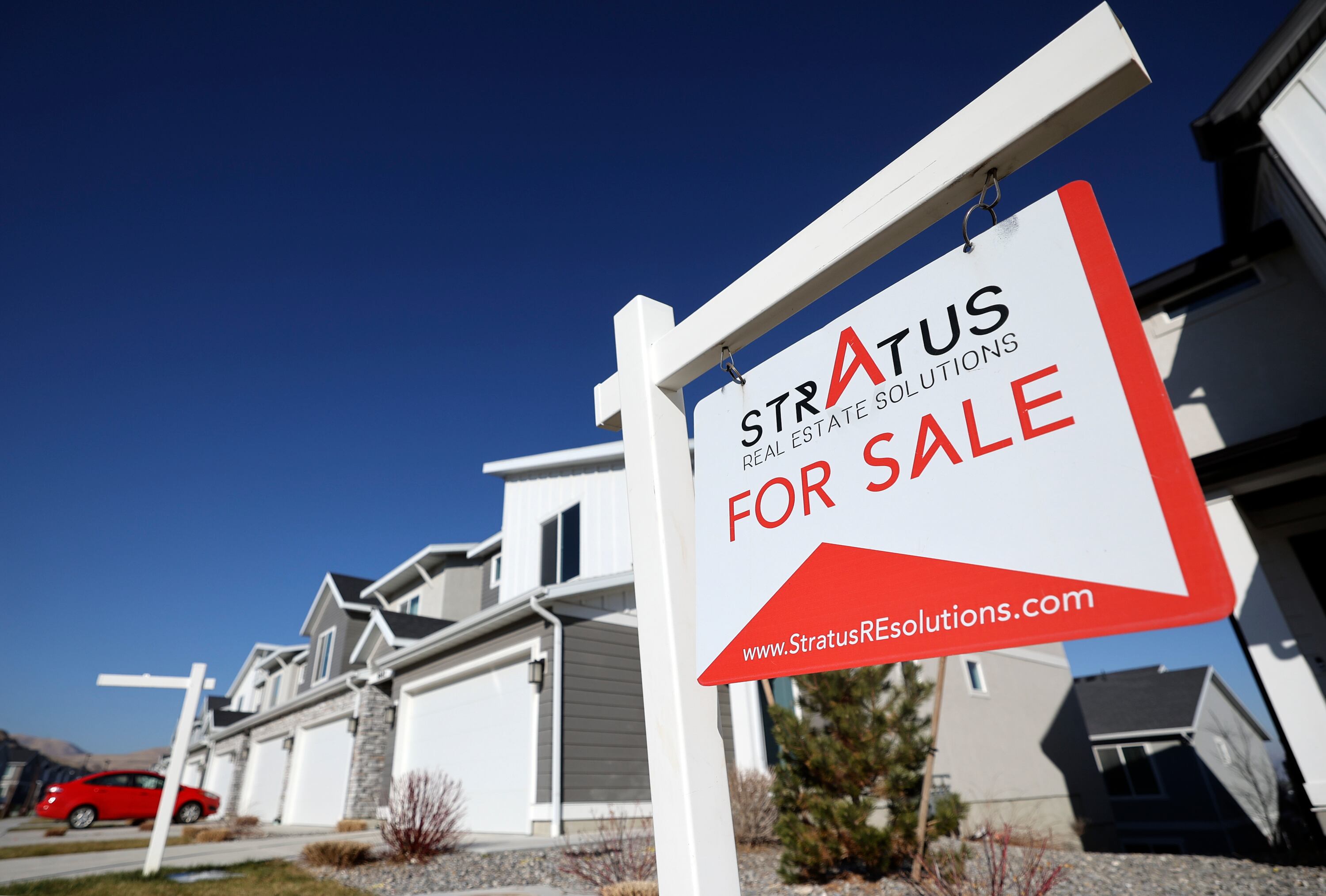 A home for sale is pictured in Magna on Tuesday. Experts believe Americans are learning to deal with the ups and downs of the housing market.