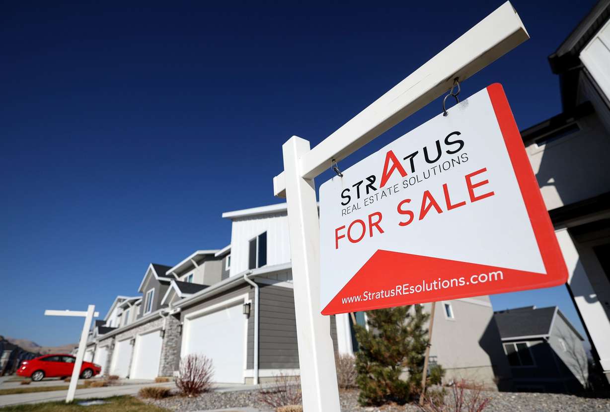 A home for sale is pictured in Magna on Tuesday. Experts believe Americans are learning to deal with the ups and downs of the housing market.