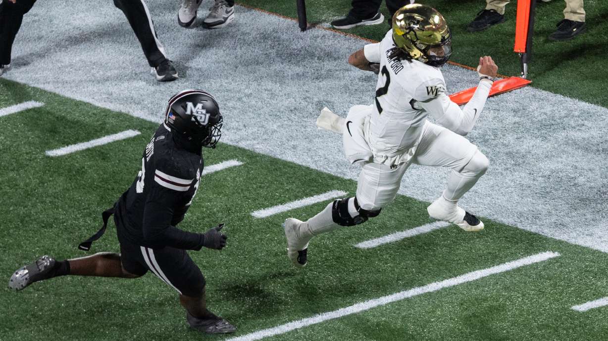 Wake Forest quarterback Robby Ashford (2) runs for a first down against Mississippi State during the first half of an NCAA college football game, Friday, Jan. 2, 2026, in Charlotte, N.C.