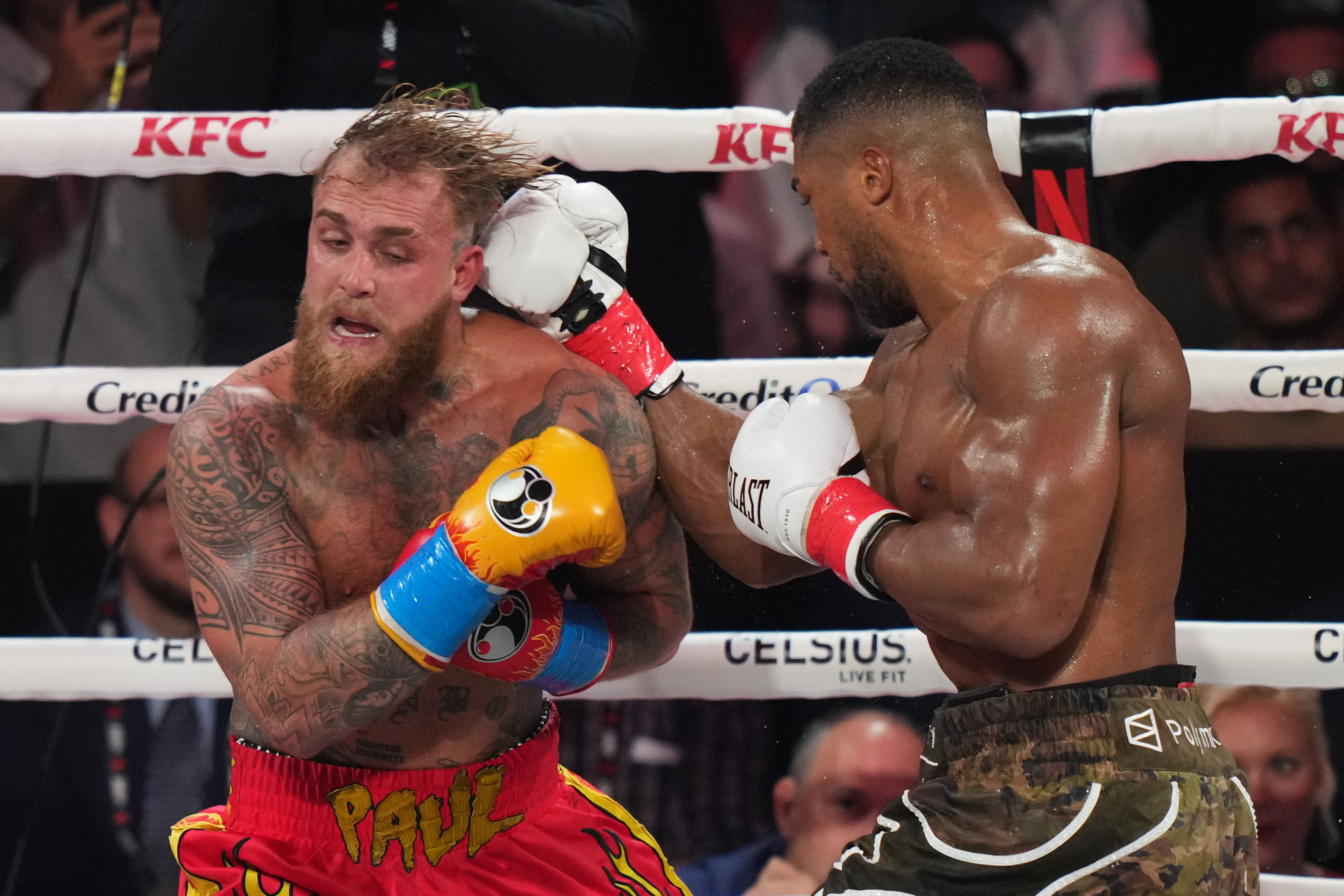 Anthony Joshua, right, punches Jake Paul during their heavyweight boxing match, Friday, Dec. 19, 2025, in Miami, Fla.