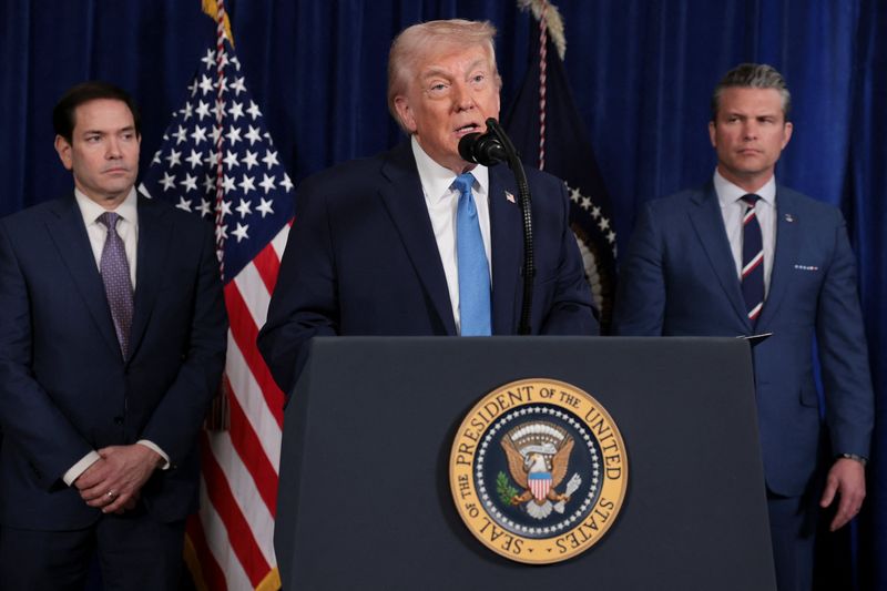 President Donald Trump speaks as Secretary of State Marco Rubio and Secretary of Defense Pete Hegseth look on during a press conference at Trump's Mar-a-Lago club in Palm Beach, Fla., Saturday. Trump said Rubio and Hegseth would be part of the team that would oversee Venezuela.