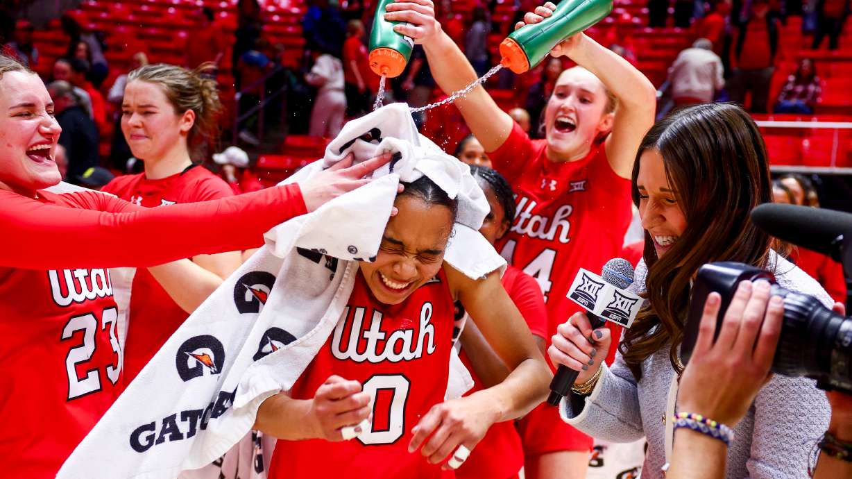 Utah guard Lani White (0) is doused by her teammates during an interview after Utah defeated the No. 8 TCU Horned Frogs 87-77 in overtime at the Huntsman Center in Salt Lake City on Saturday, Jan. 3, 2026.