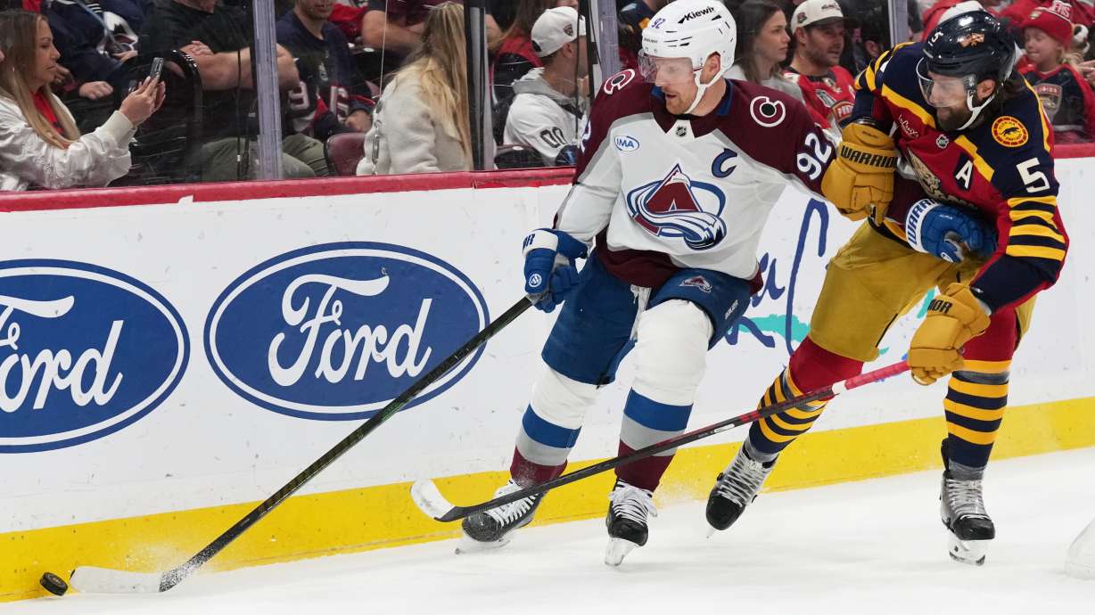 Colorado Avalanche left wing Gabriel Landeskog (92) skates with the puck as Florida Panthers defenseman Donovan Sebrango (6) defends during the first period of an NHL hockey game, Sunday, Jan. 4, 2026, in Sunrise, Fla.