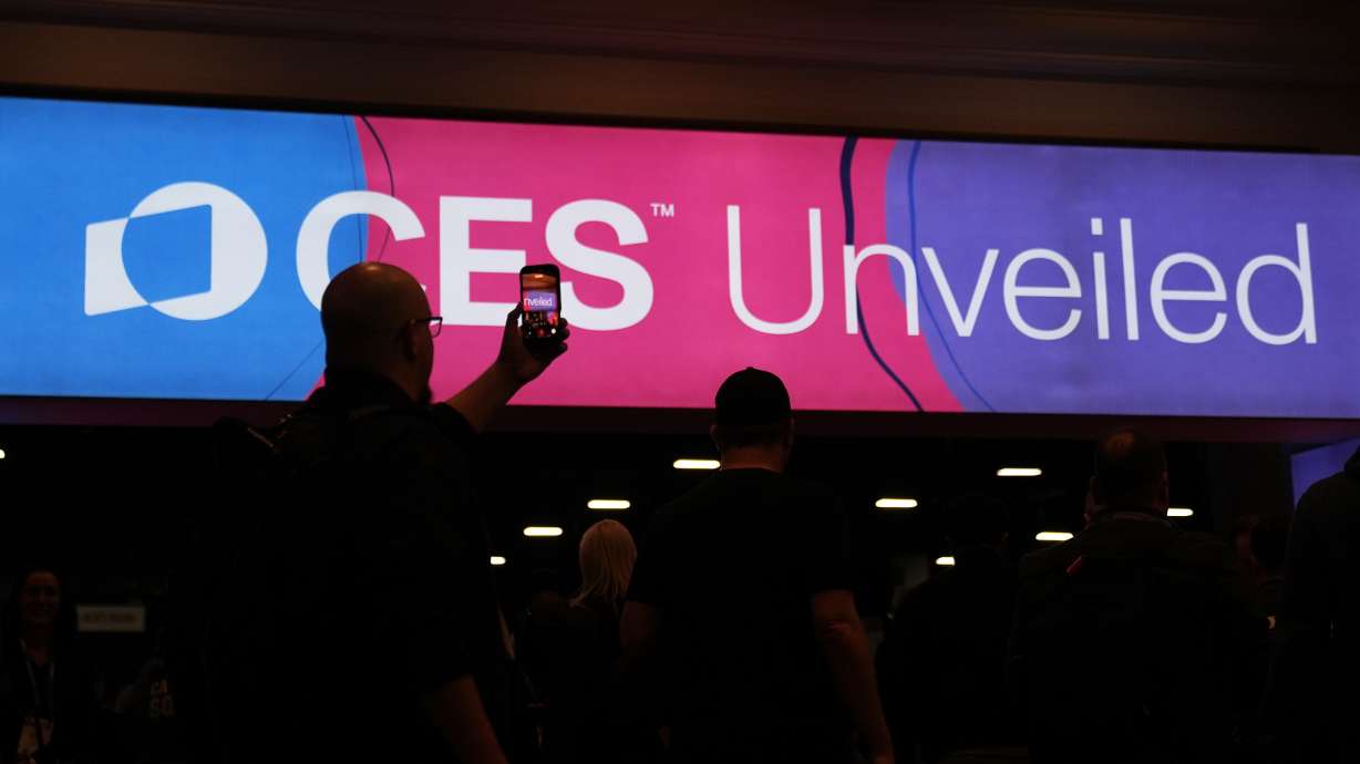 People arrive at the CES Unveiled tech show Sunday in Las Vegas.