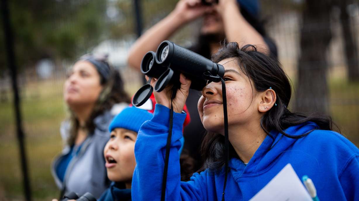 Estrella Segovia, facilities assistant manager, right, helps a family look for birds during Tracy Aviary’s first bilingual Christmas Bird Count at Tracy Aviary’s Nature Center at Pia Okwai in South Salt Lake on Sunday. The bird count encourages families to help in local bird conservation efforts by collecting population data on various native species.