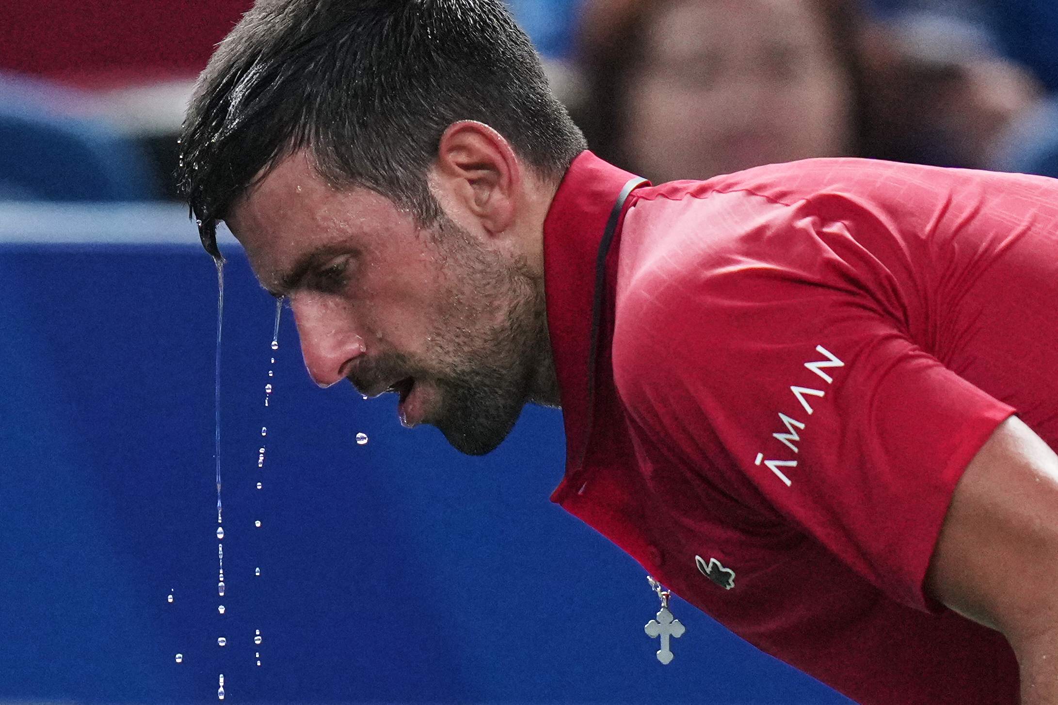FILE - Novak Djokovic of Serbia cools himself with water during the men's singles semifinal match with Valentin Vacherot of Monaco, at the Shanghai Masters tennis tournament at Qizhong Forest Sports City Tennis Center, in Shanghai, China, Saturday, Oct. 11, 2025.