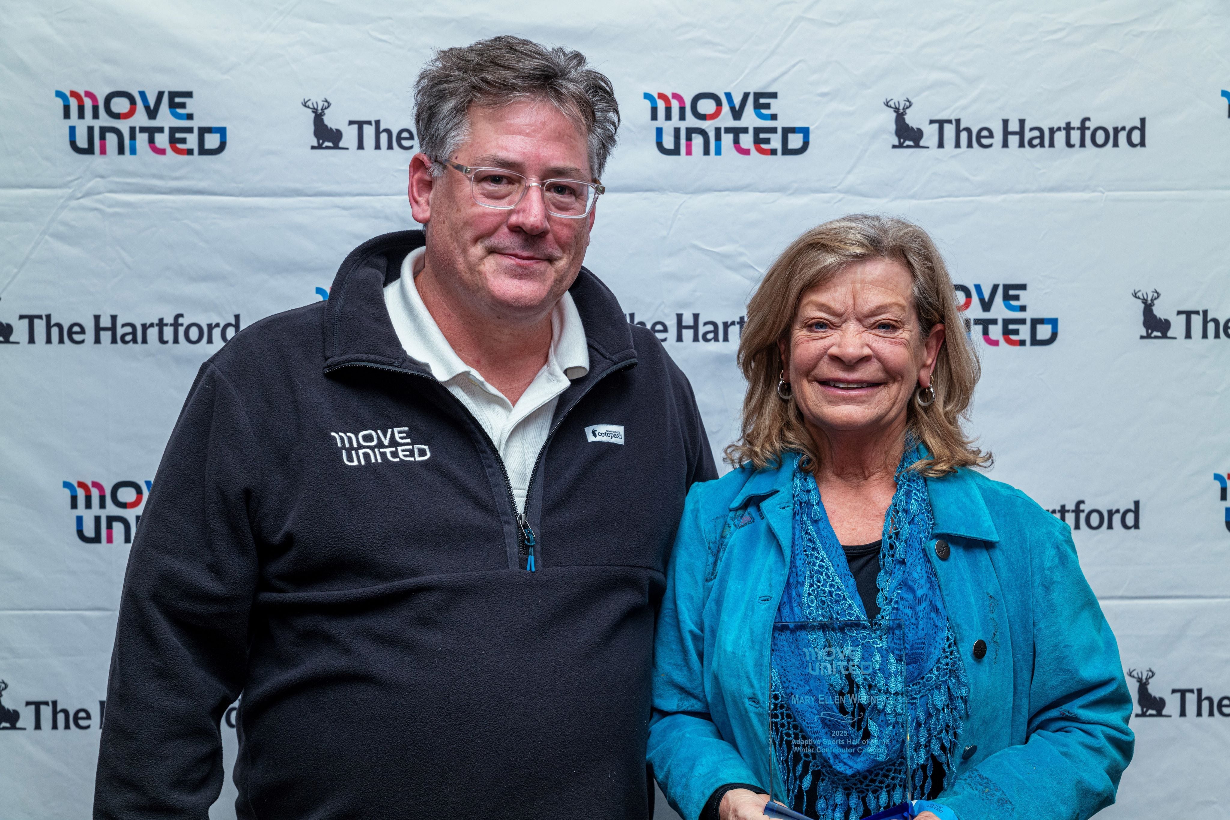 Mary Ellen "Mare" Whitney poses with Move United CEO Glenn Merry. Whitney was inducted into the National Adaptive Sports Hall of Fame.