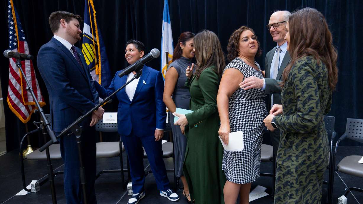 Members of the Salt Lake City Council and Mayor Erin Mendenhall converse after the oath of office ceremony during an inauguration event at the Salt Lake City Public Library in Salt Lake City on Monday.