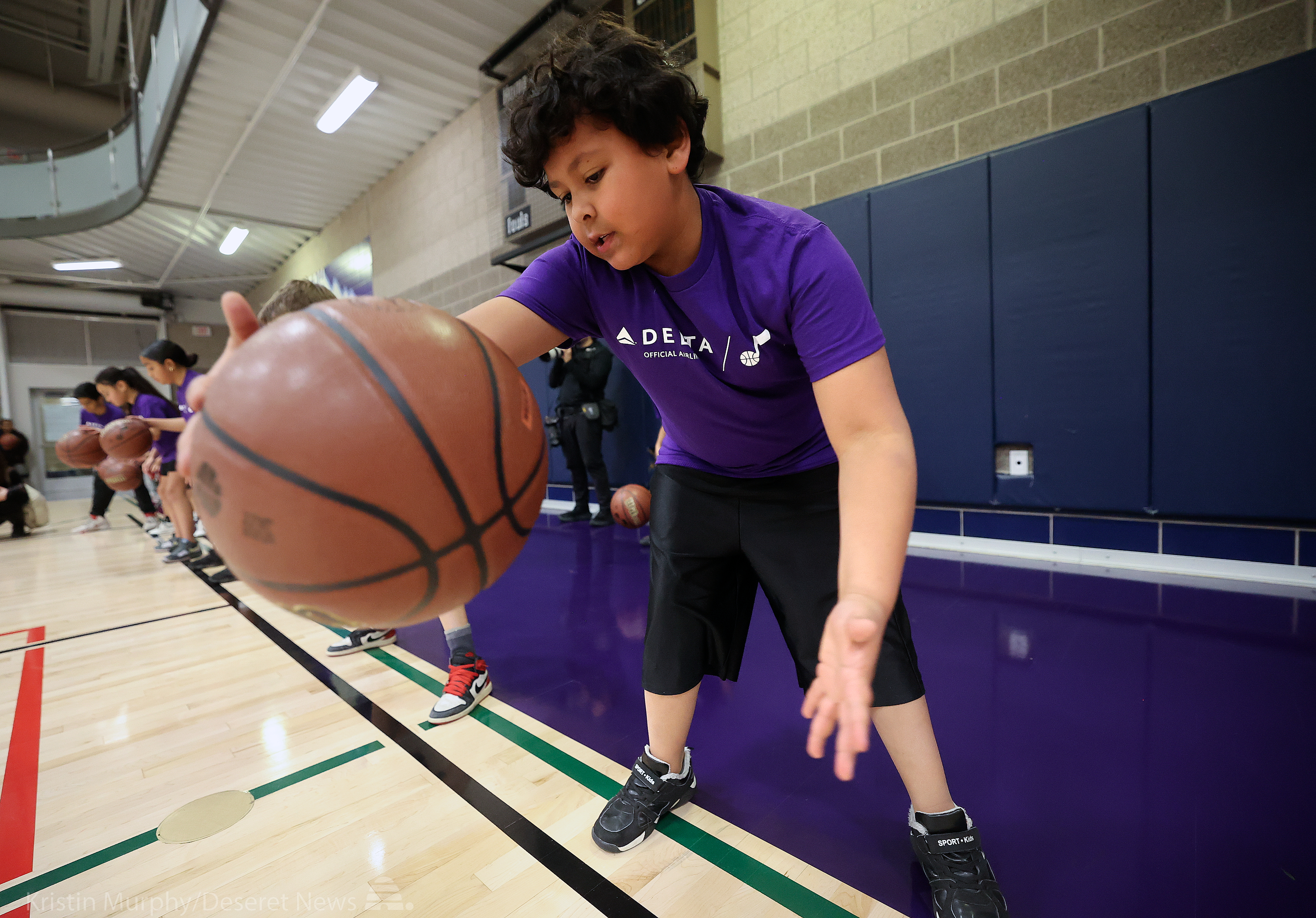 Malachi Gonzales, 9, dribbles during a Junior Jazz basketball clinic on a refurbished basketball court, funded by Delta Airlines in partnership with the Utah Jazz, at the Northwest Recreation Center in Salt Lake City on Monday.