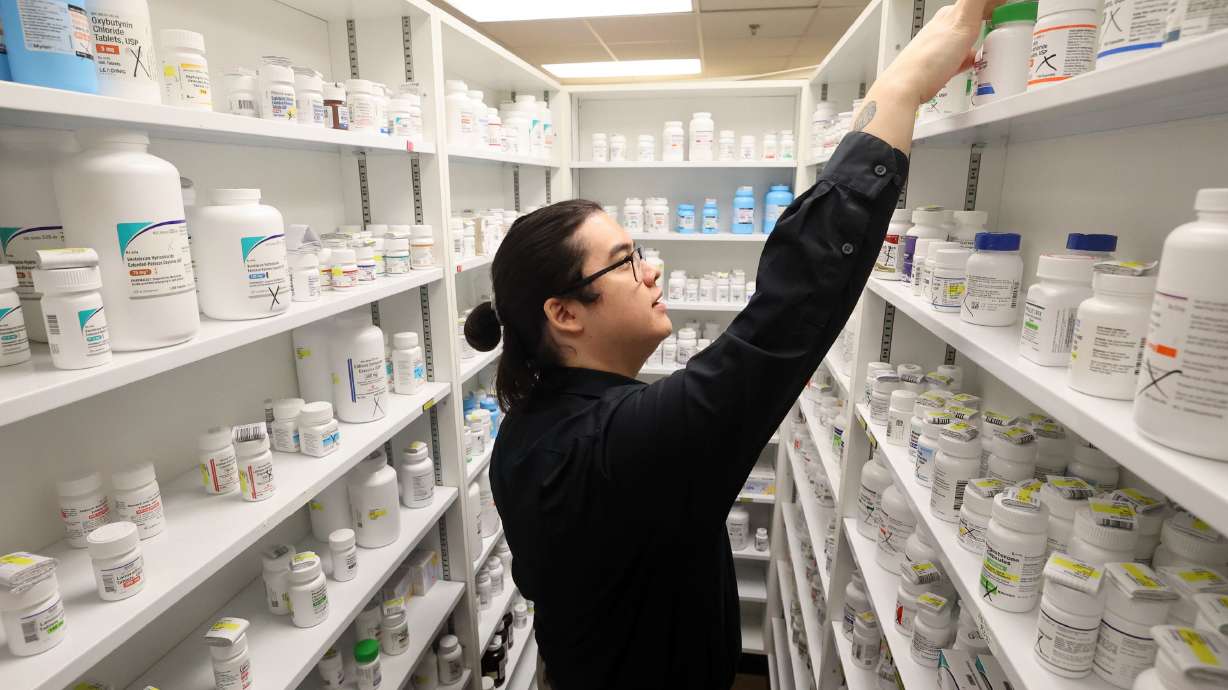 Mathew Waters, pharmacy technician trainee, looks for a medication at the Apothecary Shoppe pharmacy in Salt Lake City on Oct. 1, 2024. A pilot effort for an AI-driven platform for drug prescription renewals was approved recently.