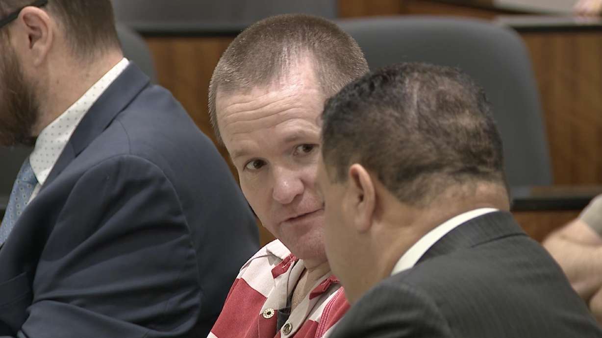 Michael Jayne speaks with his attorney during his preliminary hearing on Tuesday Jan. 6. He is charged with capital murder in the death of a Santaquin police officer.
