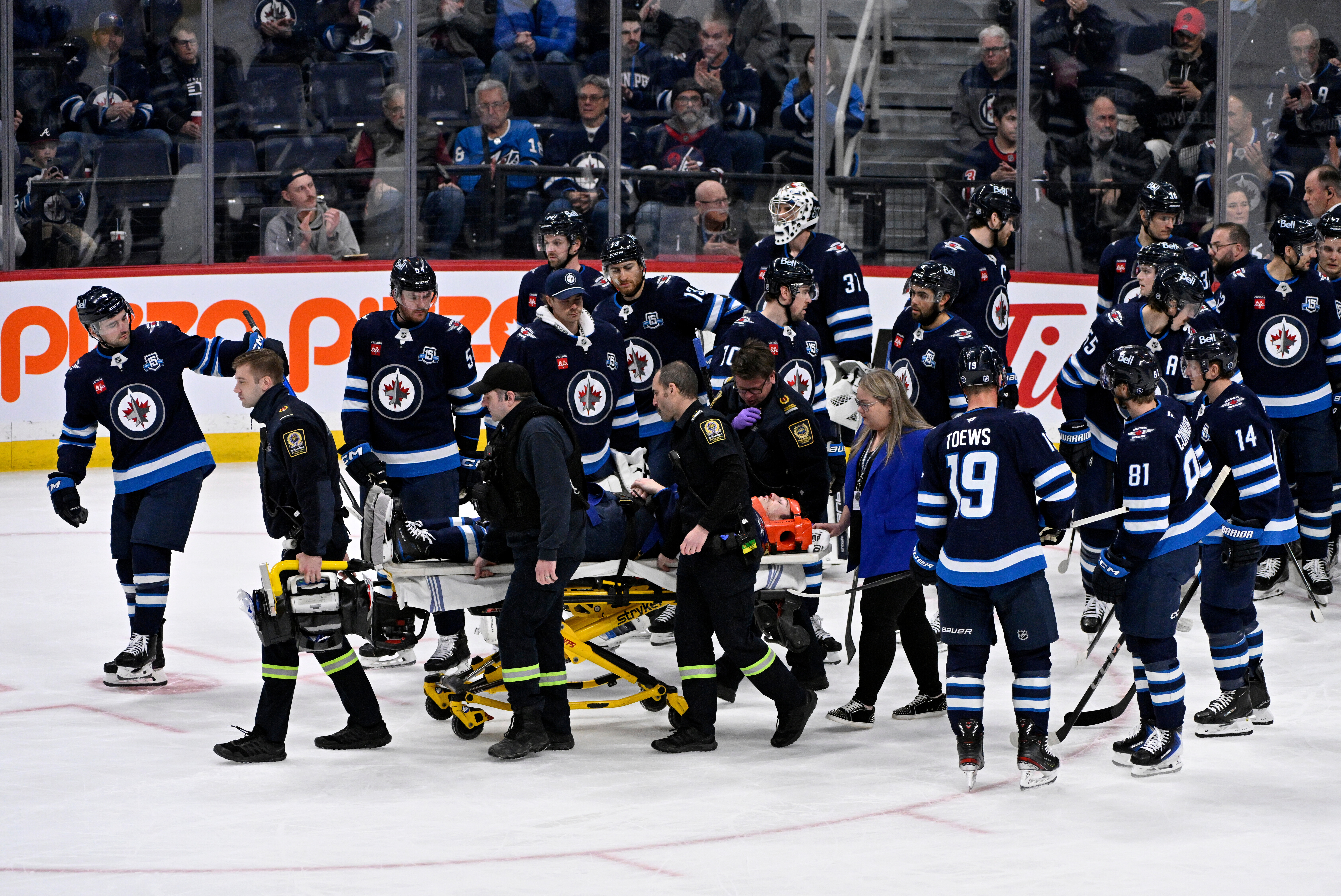 Winnipeg Jets' Haydn Fleury is helped off the ice after being injured against the Vegas Golden Knights during the first period of their NHL hockey game in Winnipeg, Tuesday Jan. 6, 2026.