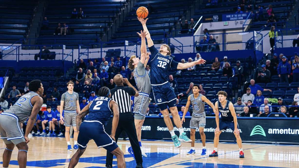 Utah State center Zach Keller (32) goes after the opening tip Tuesday night at Air Force.