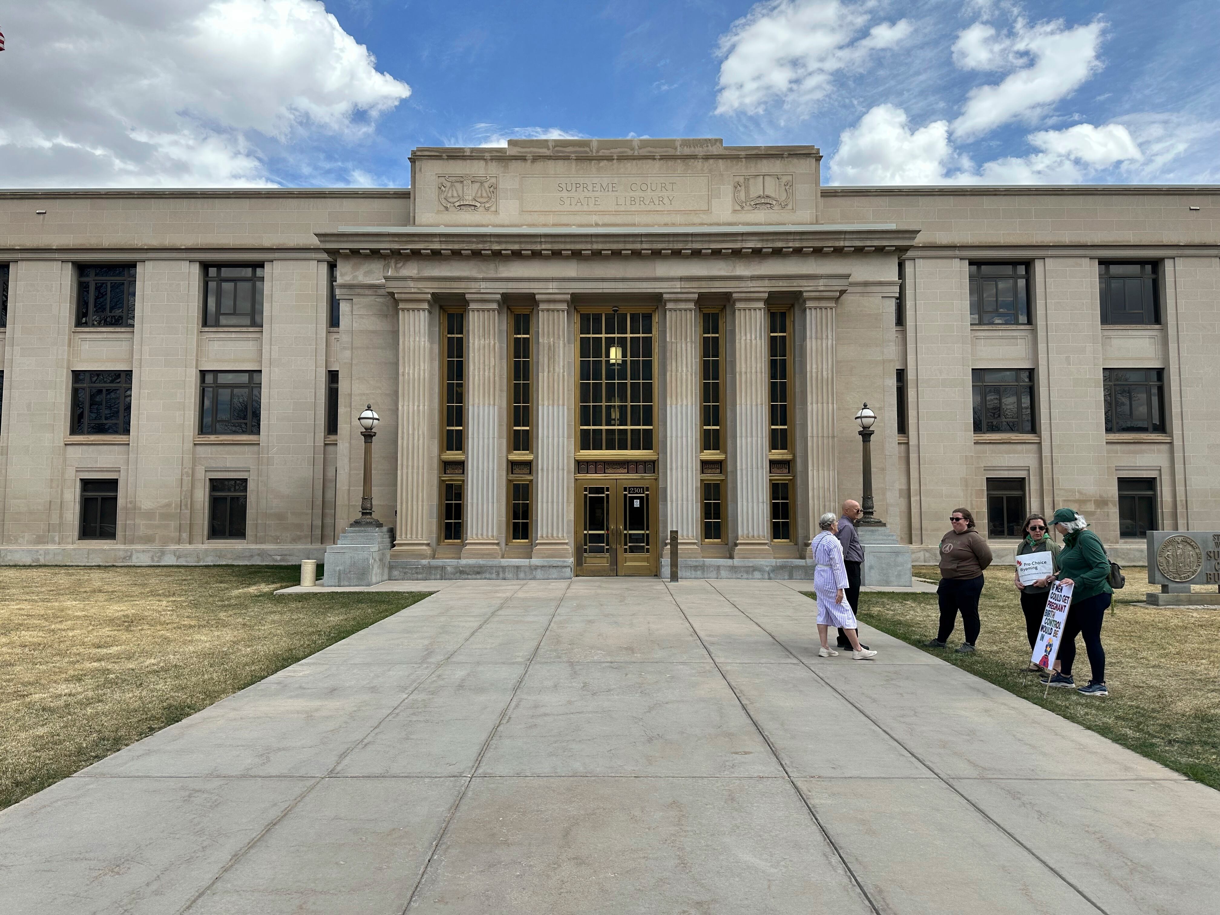 Demonstrators stand before the Wyoming Supreme Court building in Cheyenne ahead of arguments over the state's abortion bans, April 16. The 4-1 decision on Tuesday against the state's near-total abortion ban could be a foreshadowing in Utah.