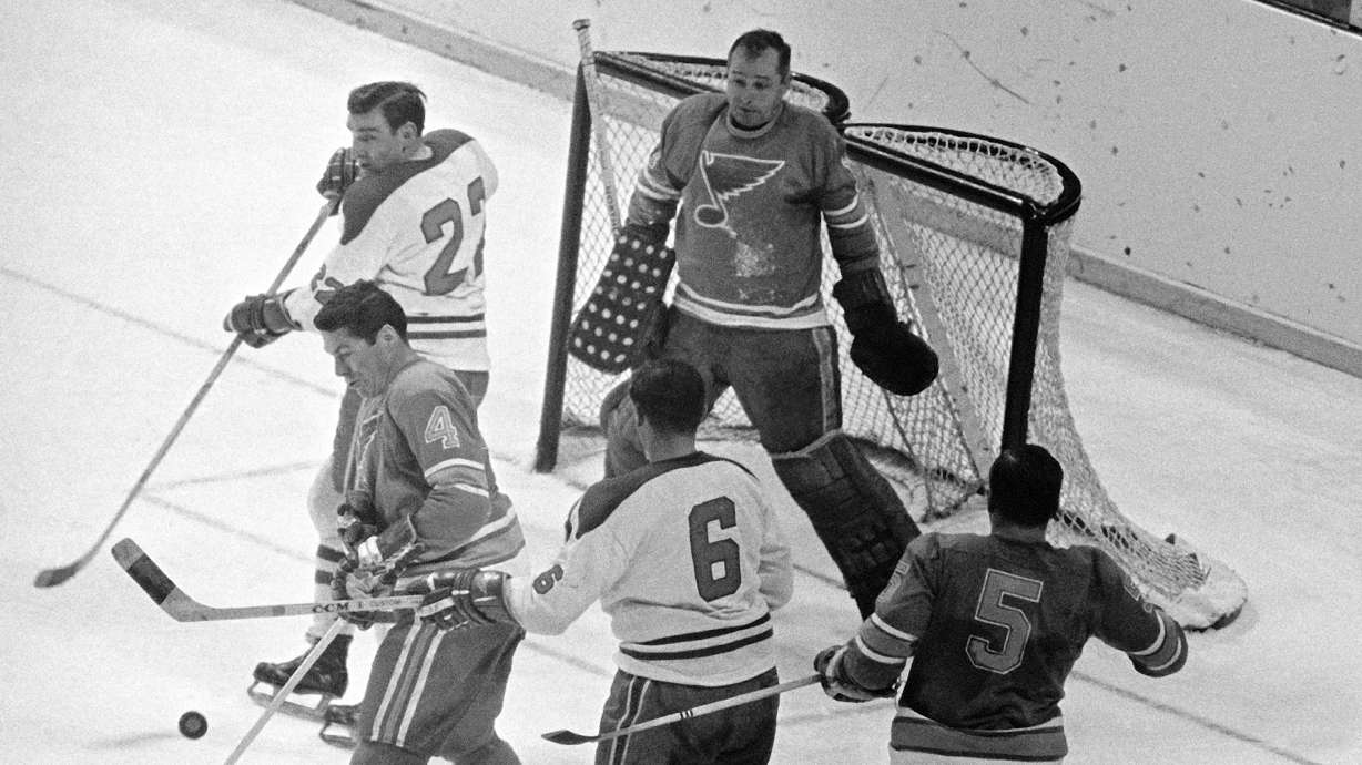 FILE - St. Louis Blues goalie Glenn Hall, top right, is pinned to his net waiting to make a save on a Montreal Canadians shot as Blues' Noel Picard (4) tries to block the puck while Canadiens' John Ferguson (22) and Ralph Backstorm wait for a rebound in the third period of their NHL hockey Stanley Cup game, May 5, 1968.