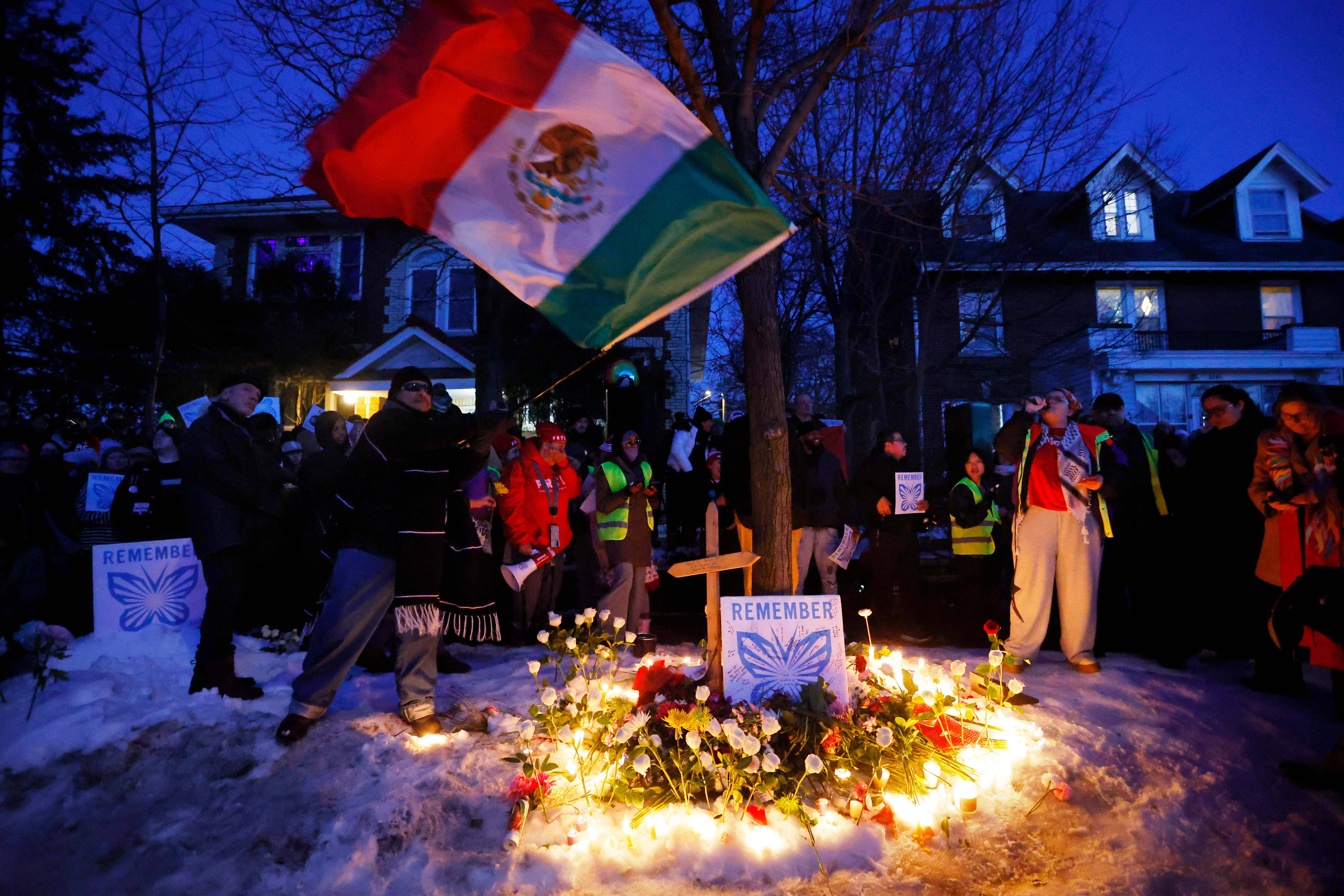 People gather for a vigil after an Immigration and Customs Enforcement officer shot and killed a woman earlier in the day, Wednesday, in Minneapolis.