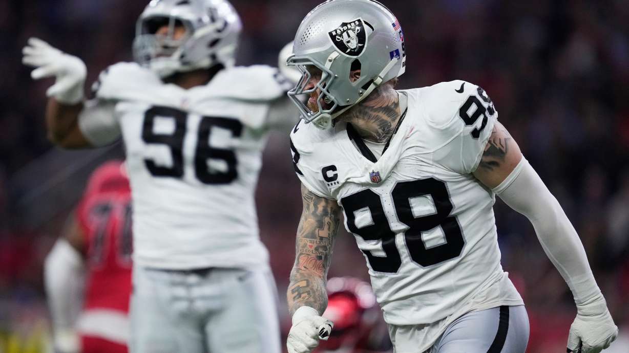 Las Vegas Raiders defensive tackle Jonah Laulu (96) and defensive end Maxx Crosby (98) celebrate during the second half of an NFL football game against the Houston Texans, Sunday, Dec. 21, 2025, in Houston.