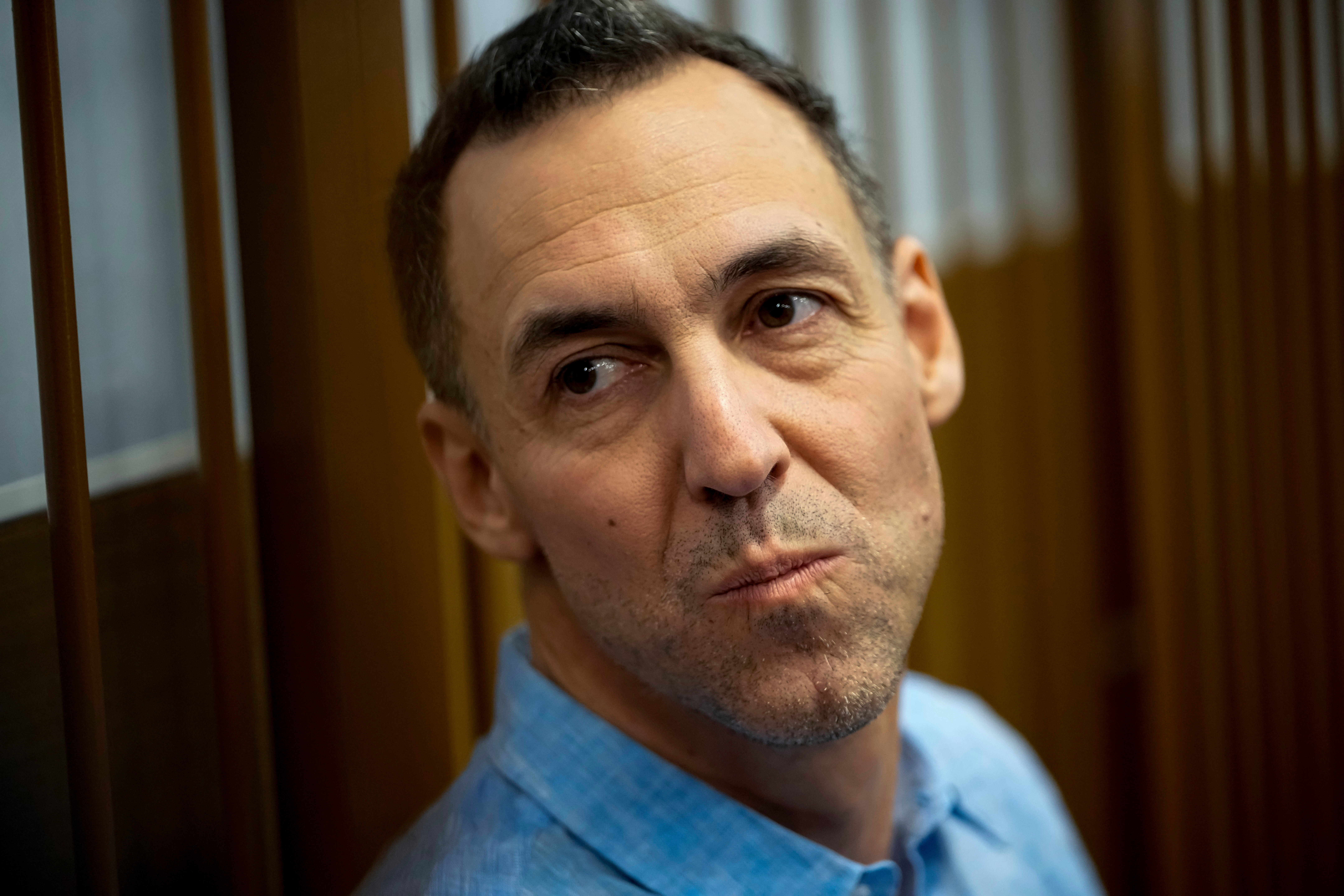 FILE - French citizen Laurent Vinatier sits in a cage prior to a court session at the Zamoskvoretsky District Court in Moscow, Oct. 14, 2024.
