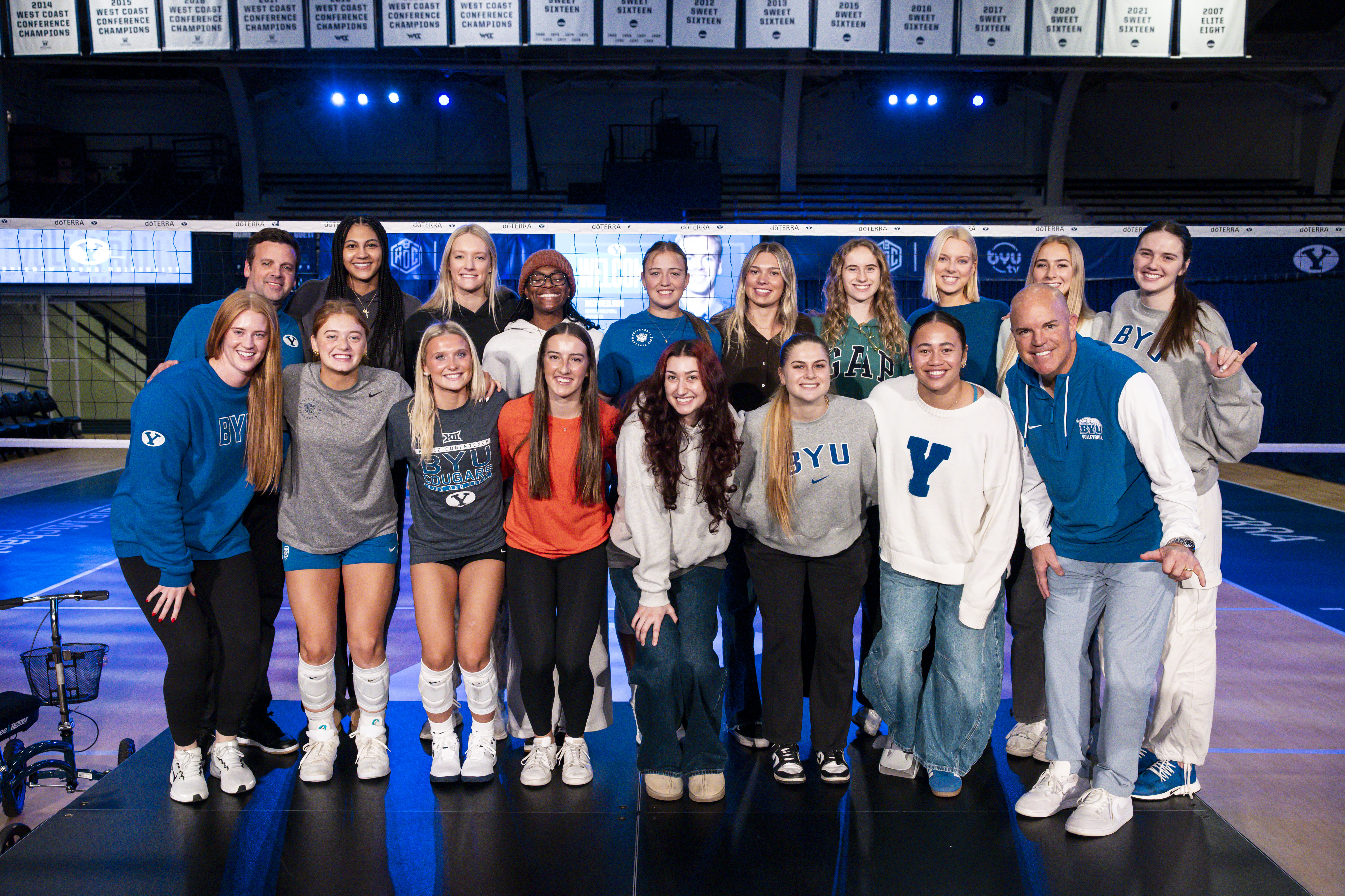 BYU women's volleyball players pose with new head coach Rob Neilson and athletic director Brian Santiago after Neilson was introduced as the Cougars' seventh women's volleyball head coach, Thursday, Jan. 8, 2025 in Provo, Utah.