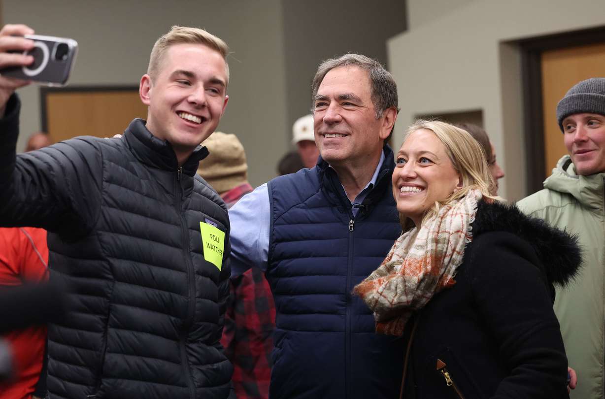Rep. Brian King, Democratic nominee for Utah governor, and Rebekah Cummings, Democratic nominee for Utah lieutenant governor, have a selfie taken by poll watcher Salem Palmer while standing in line to vote at Hogle Zoo in Salt Lake City on Nov. 5, 2024.