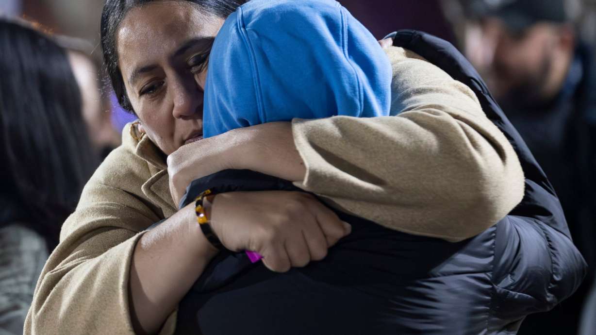 People console each other as Salt Lake City police officers investigate a shooting at a meetinghouse of The Church of Jesus Christ of Latter-day Saints in Salt Lake City on Wednesday.