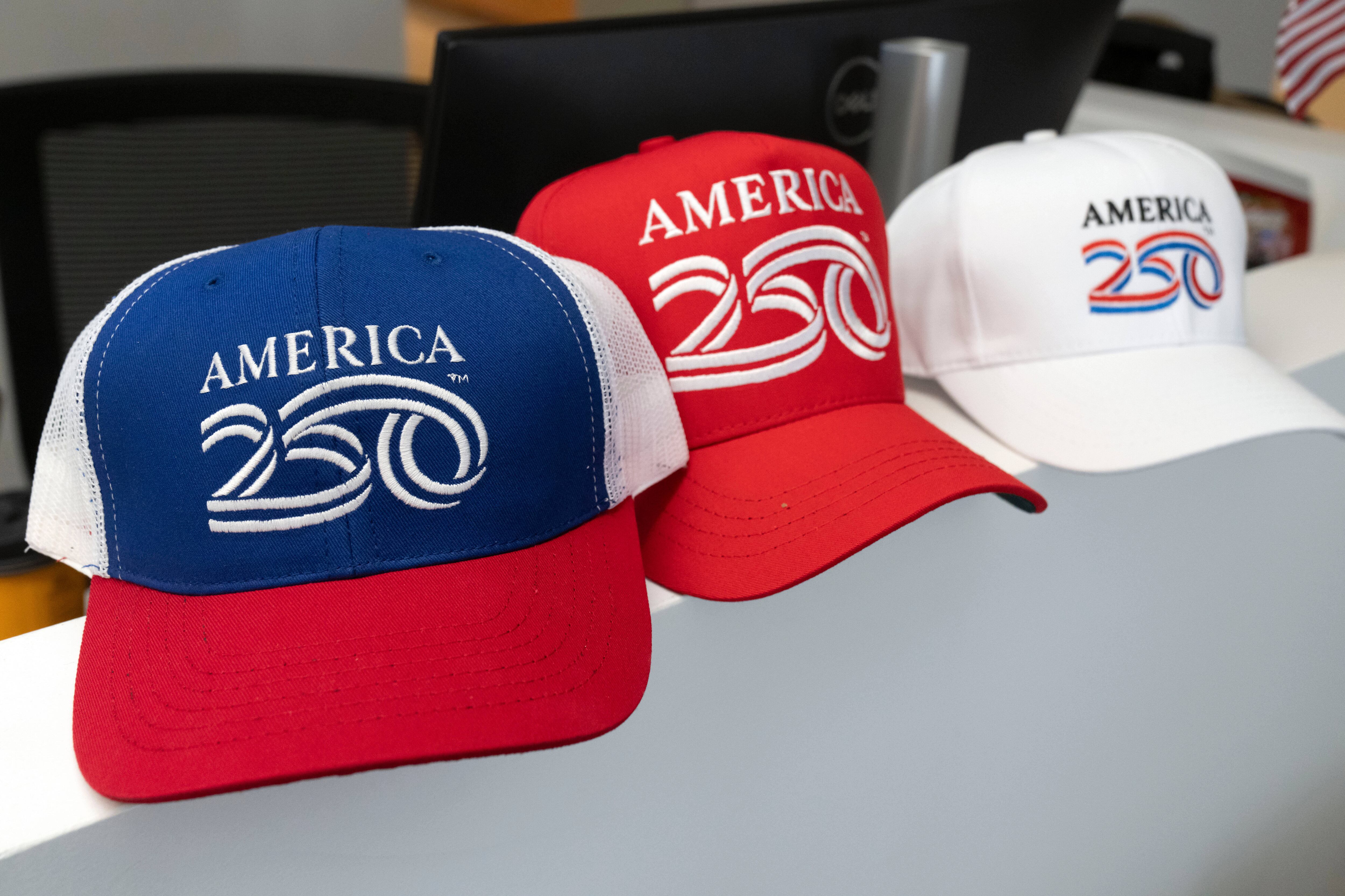 Themed caps are displayed at the offices of America250, the organization leading celebrations of the 250th anniversary of the signing of the Declaration of Independence in 1776, on Nov. 13, in Washington. America Gives is encouraging people nationwide to participate in service to commemorate the anniversary.