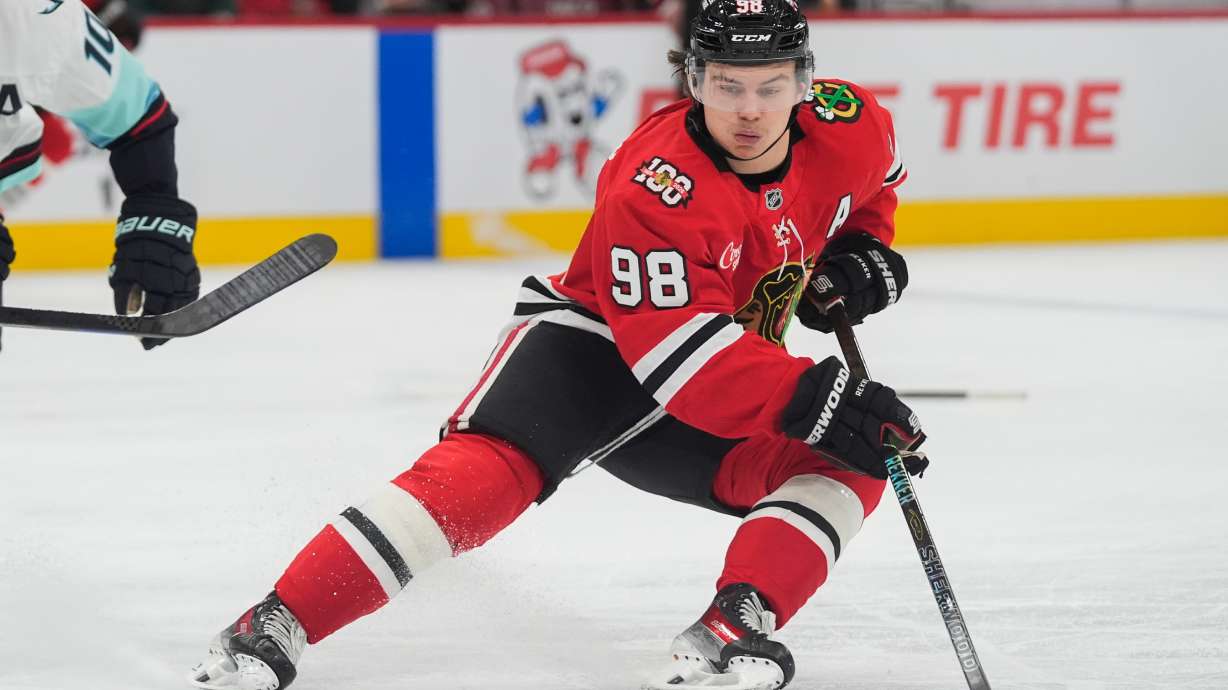 FILE - Chicago Blackhawks center Connor Bedard handles the puck during the second period of an NHL hockey game against the Seattle Kraken, Nov. 20, 2025, in Chicago.