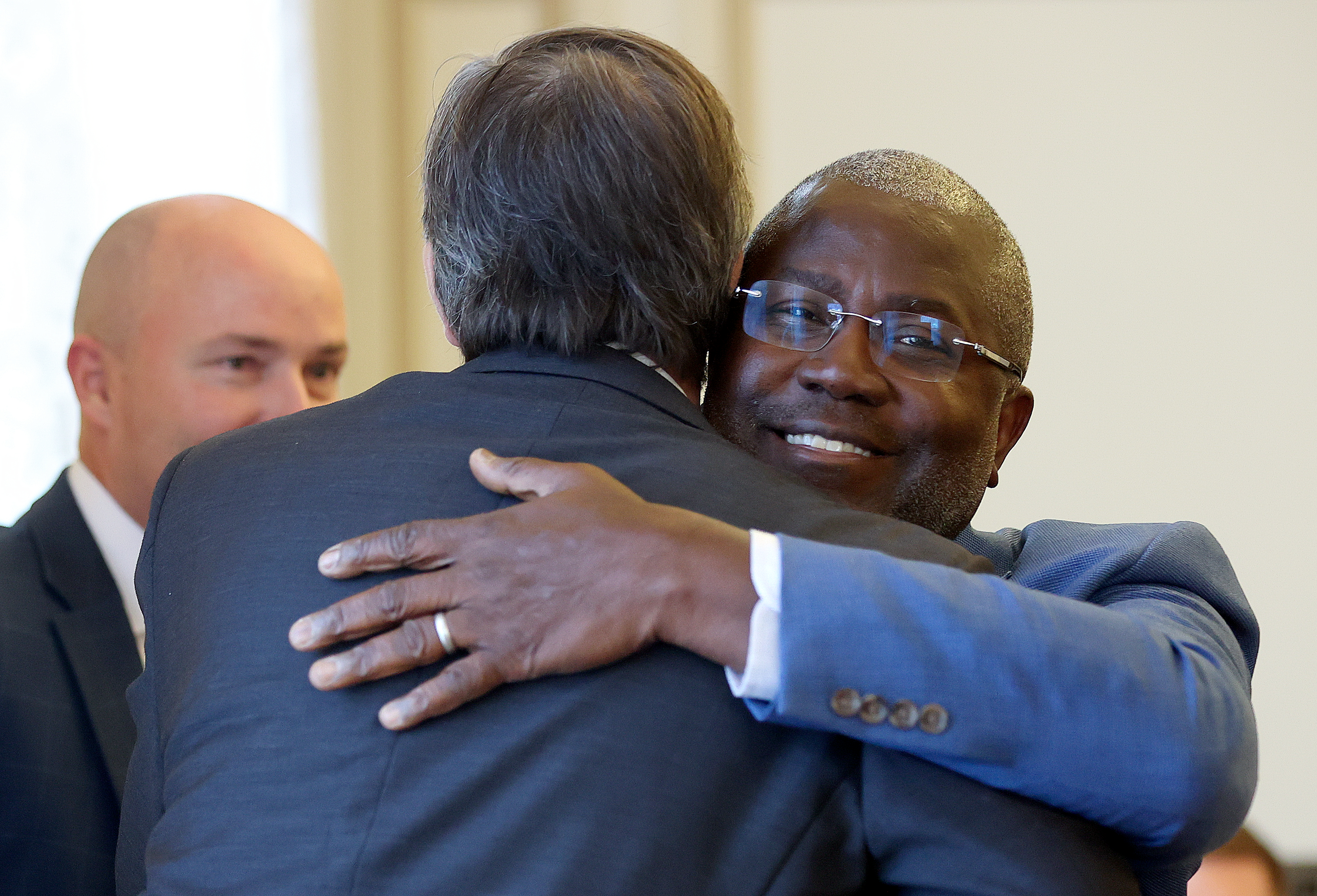 Richard Reeves, American Institute for Boys and Men president, hugs Ian Rowe, American Enterprise Institute senior fellow and Vertex Partnership Academies founder, at the Men and Boys Well-being Symposium, hosted by the Sutherland Institute, at the Thomas S. Monson Center in Salt Lake City on Thursday. The institute's new study said men still face barriers to mental health care.