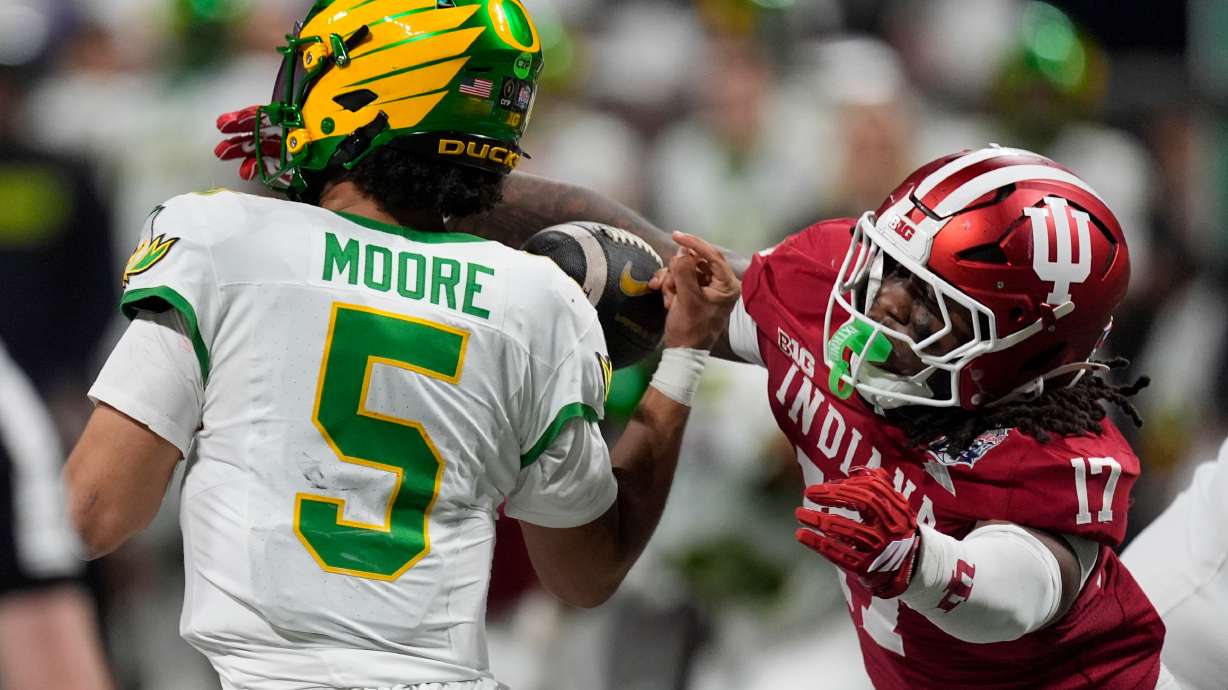 Indiana defensive lineman Daniel Ndukwe (17) pressures Oregon quarterback Dante Moore (5) during the first half of the Peach Bowl NCAA college football playoff semifinal, Friday, Jan. 9, 2026, in Atlanta.