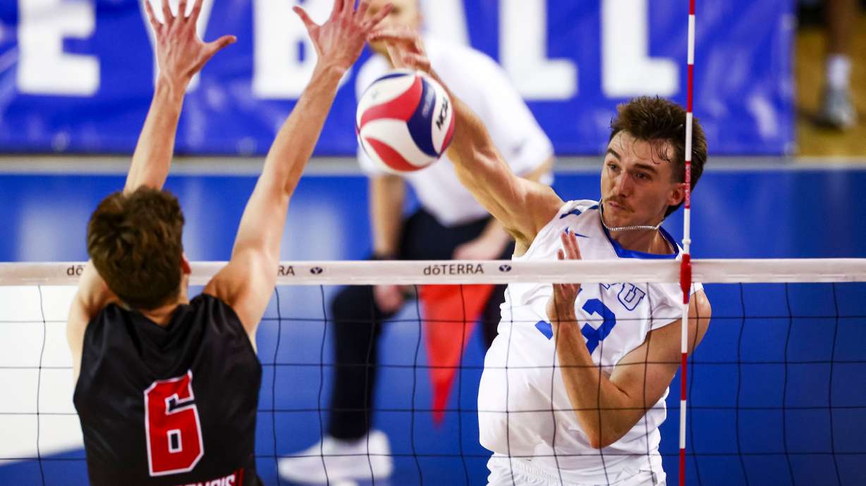 BYU outside hitter Trent Moser (13) hits the ball past a block from Saint Francis University Red Flash setter Kyle Charles (6) during an NCAA men’s volleyball game at the George Albert Smith Fieldhouse in Provo on Friday, Jan. 9, 2026.