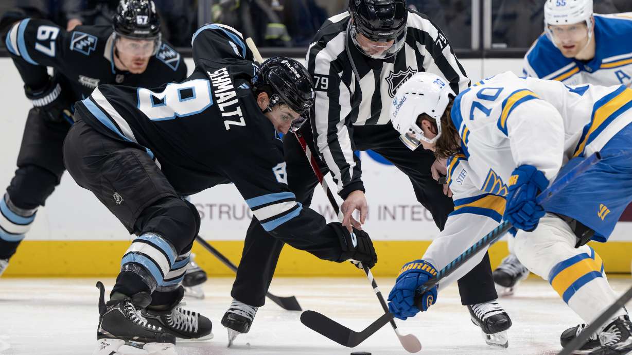Utah Mammoth center Nick Schmaltz (8) and St. Louis Blues center Oskar Sundqvist (70) face off as the Mammoth and Blues play at the Delta Center in Salt Lake City on Friday, Jan. 9, 2026.