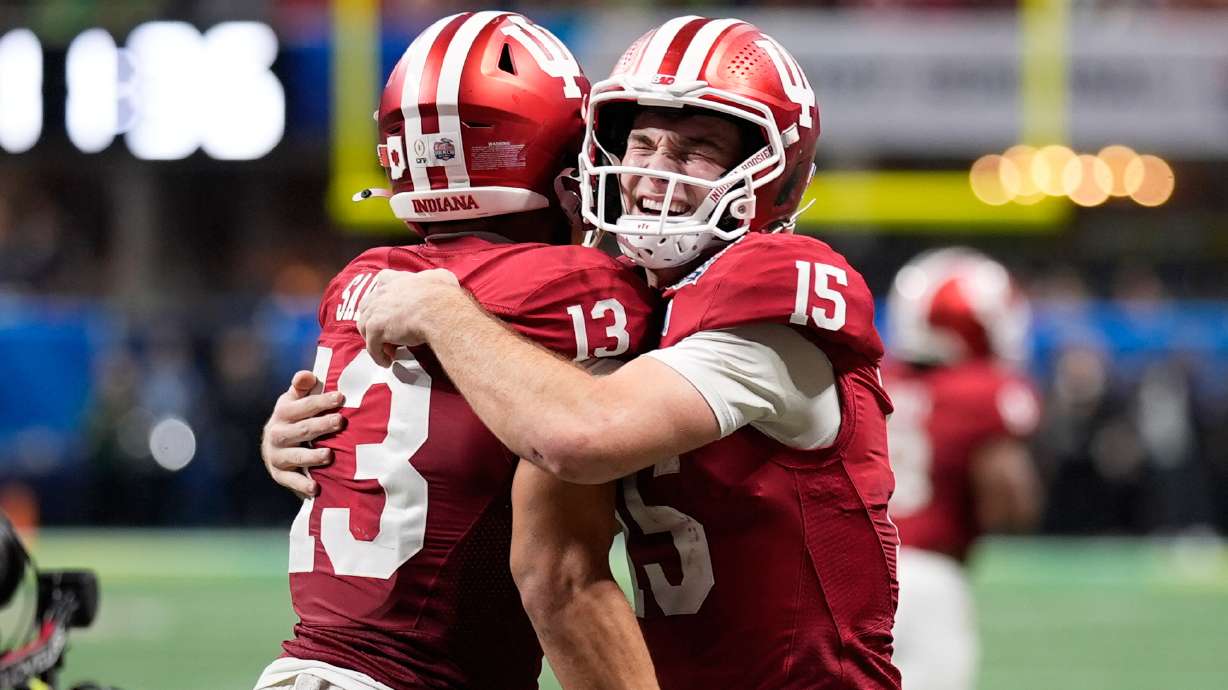 Indiana wide receiver Elijah Sarratt (13) celebrates his touchdown reception with quarterback Fernando Mendoza (15) during the second half of the Peach Bowl NCAA college football playoff semifinal, Friday, Jan. 9, 2026, in Atlanta.